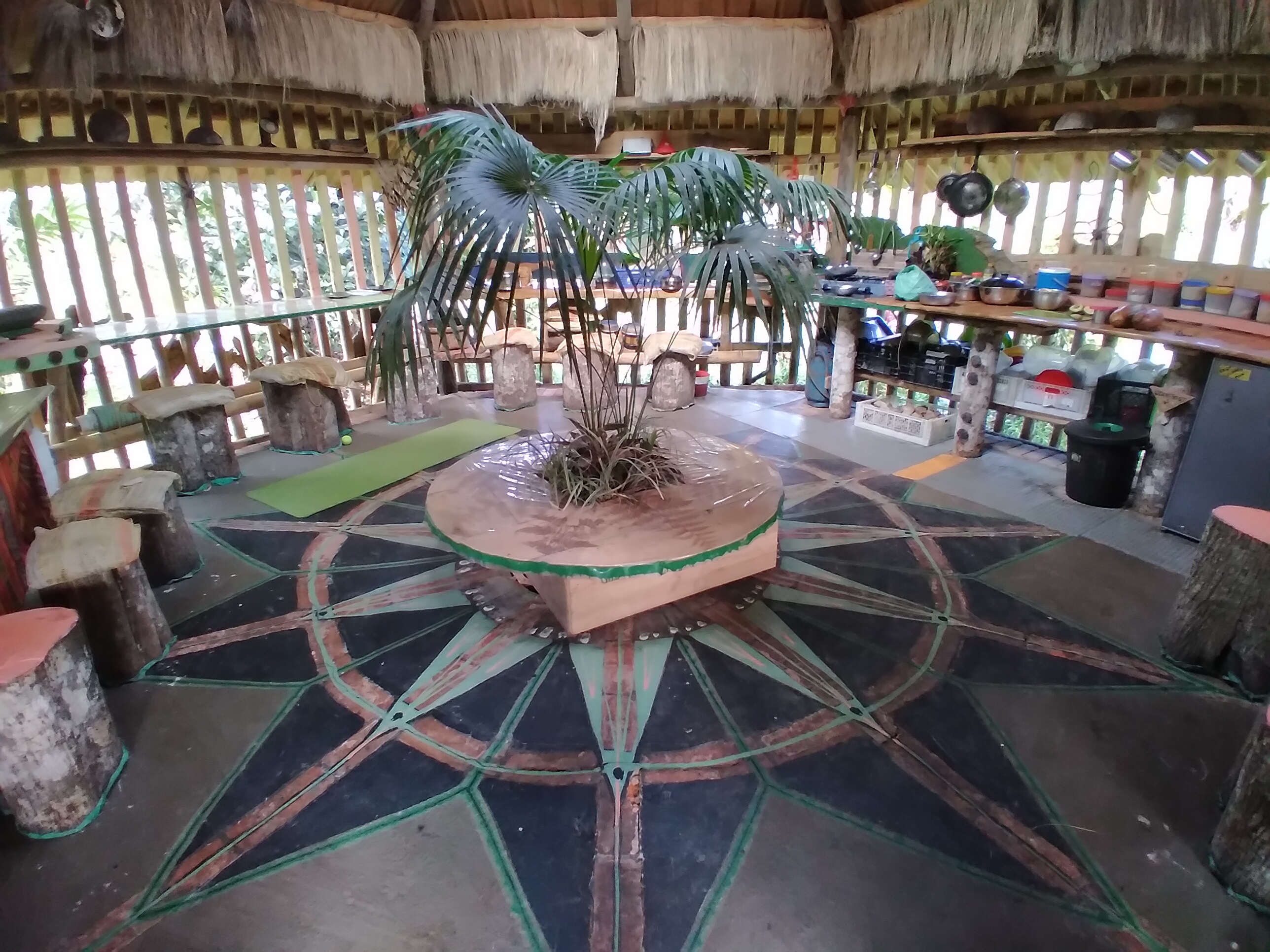 Open-air community space with a central plant and seating area.