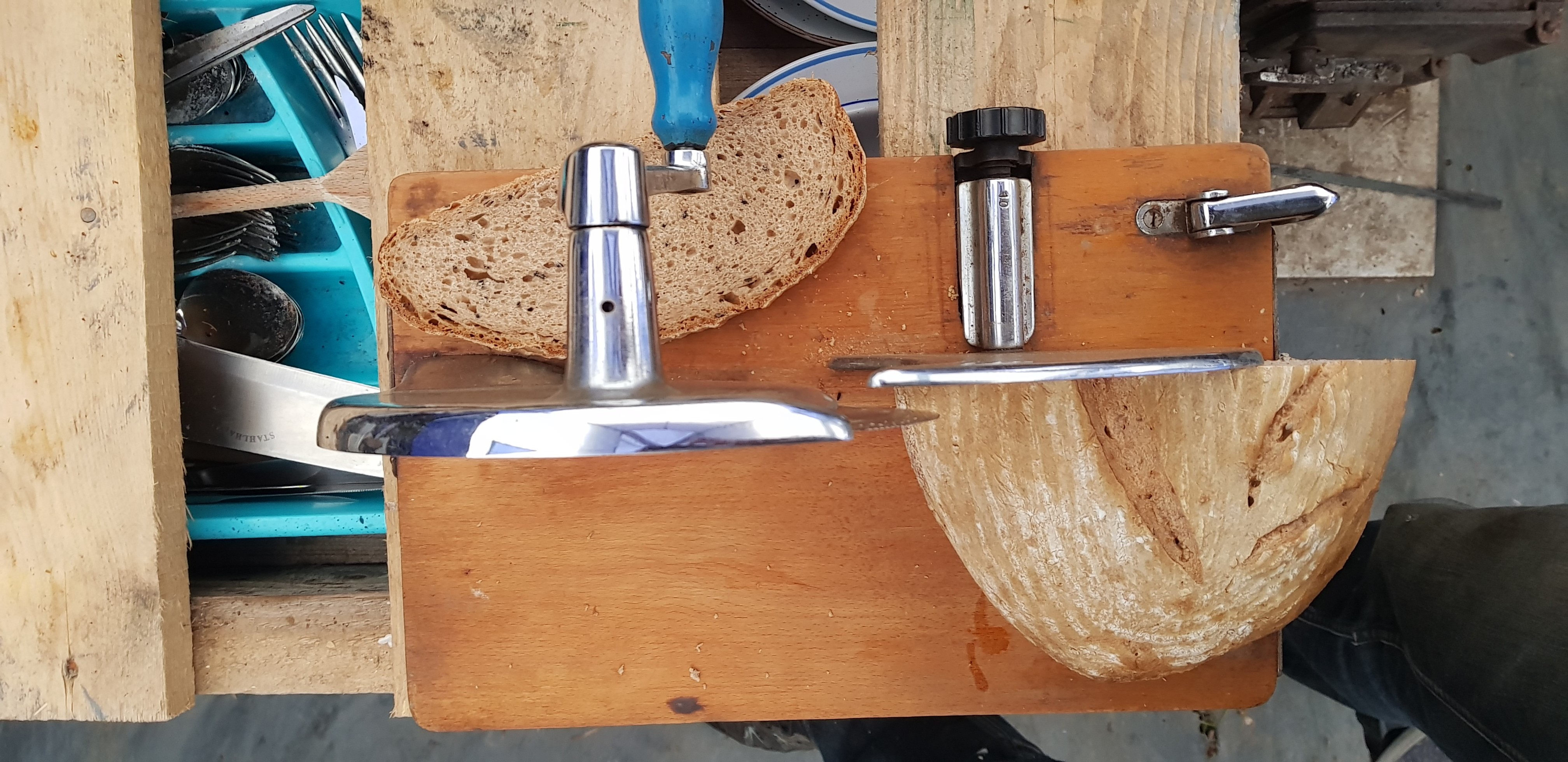 Wooden kitchen sink with faucet and soap dispenser on a wooden countertop.