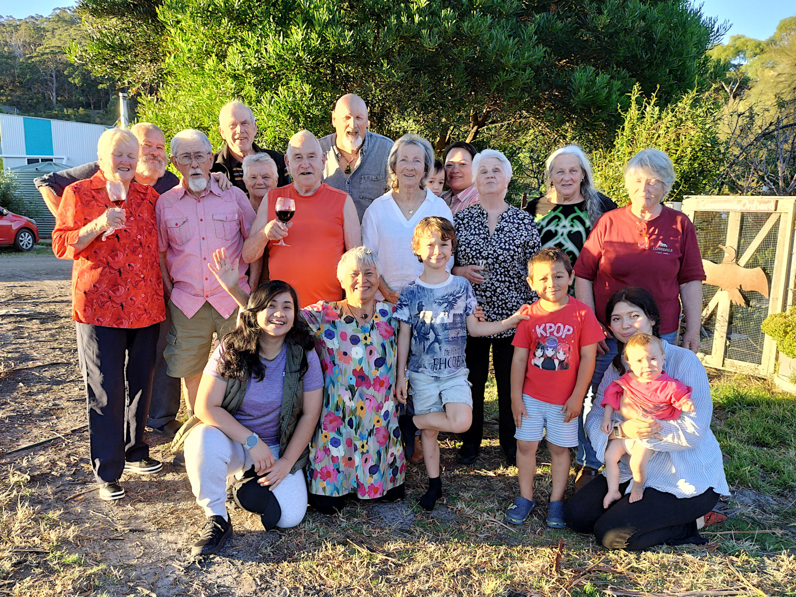 Group of diverse people enjoying outdoor community event at Tasman Ecovillage.