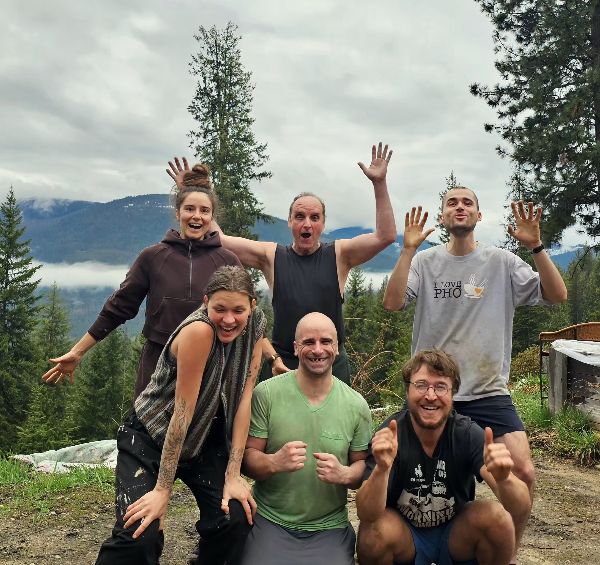 Group of people smiling and celebrating outdoors at Chuckleberry Community Farm.