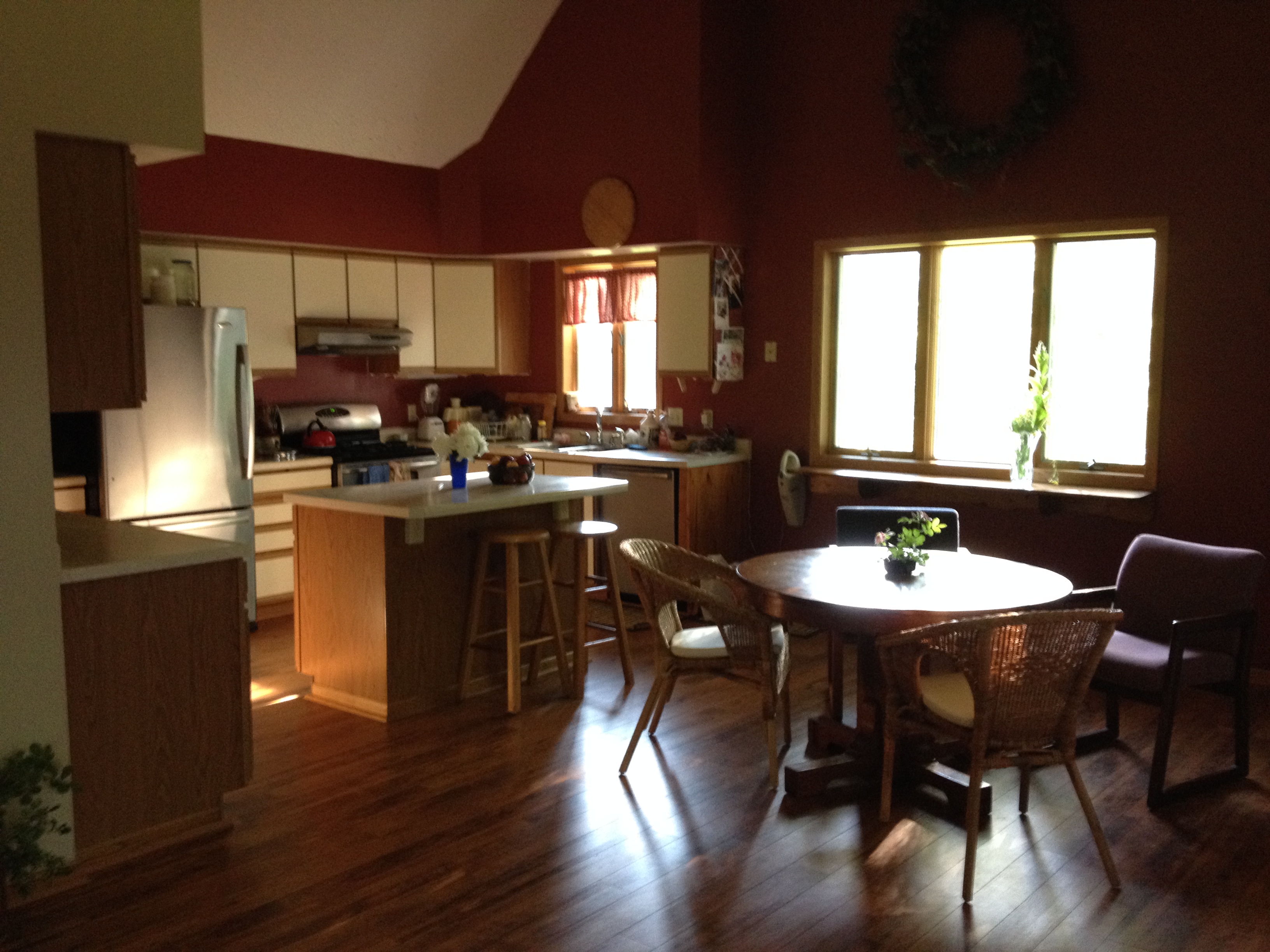 Warm kitchen and dining space with wooden furniture and natural light.