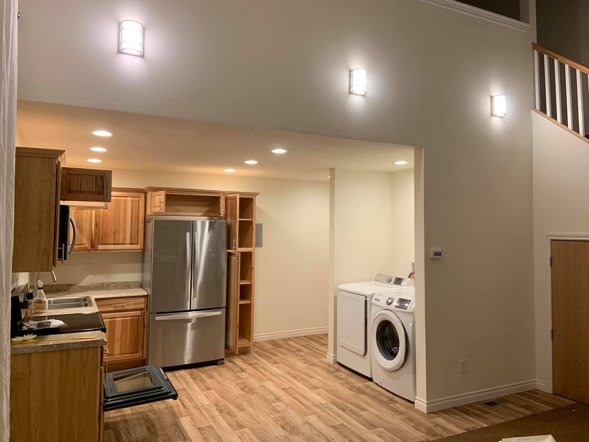 Modern kitchen and laundry area in eco-friendly co-housing community.