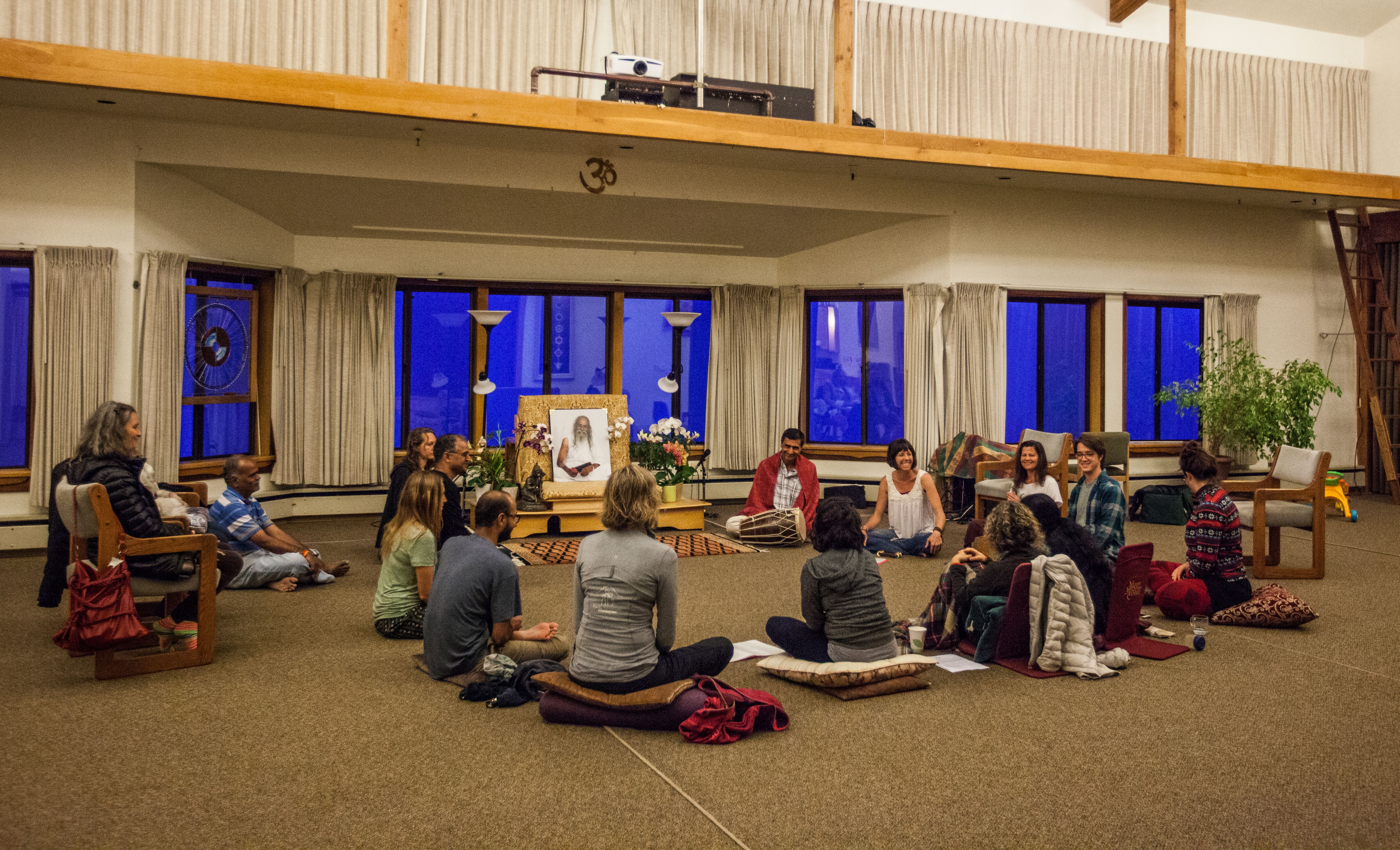 People meditating in a circle during a spiritual workshop at Mount Madonna Center.