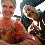 Happy community members with chicken at Foundation for Intentional Community event.
