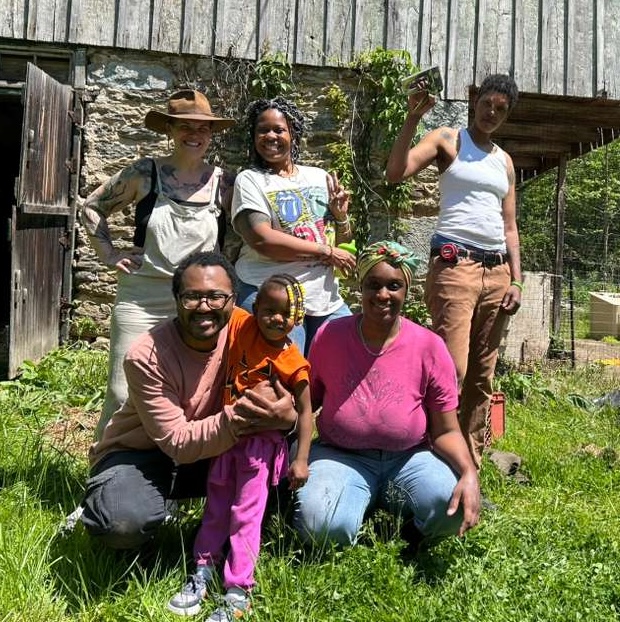 Diverse group of people smiling outdoors at Heathcote Community.