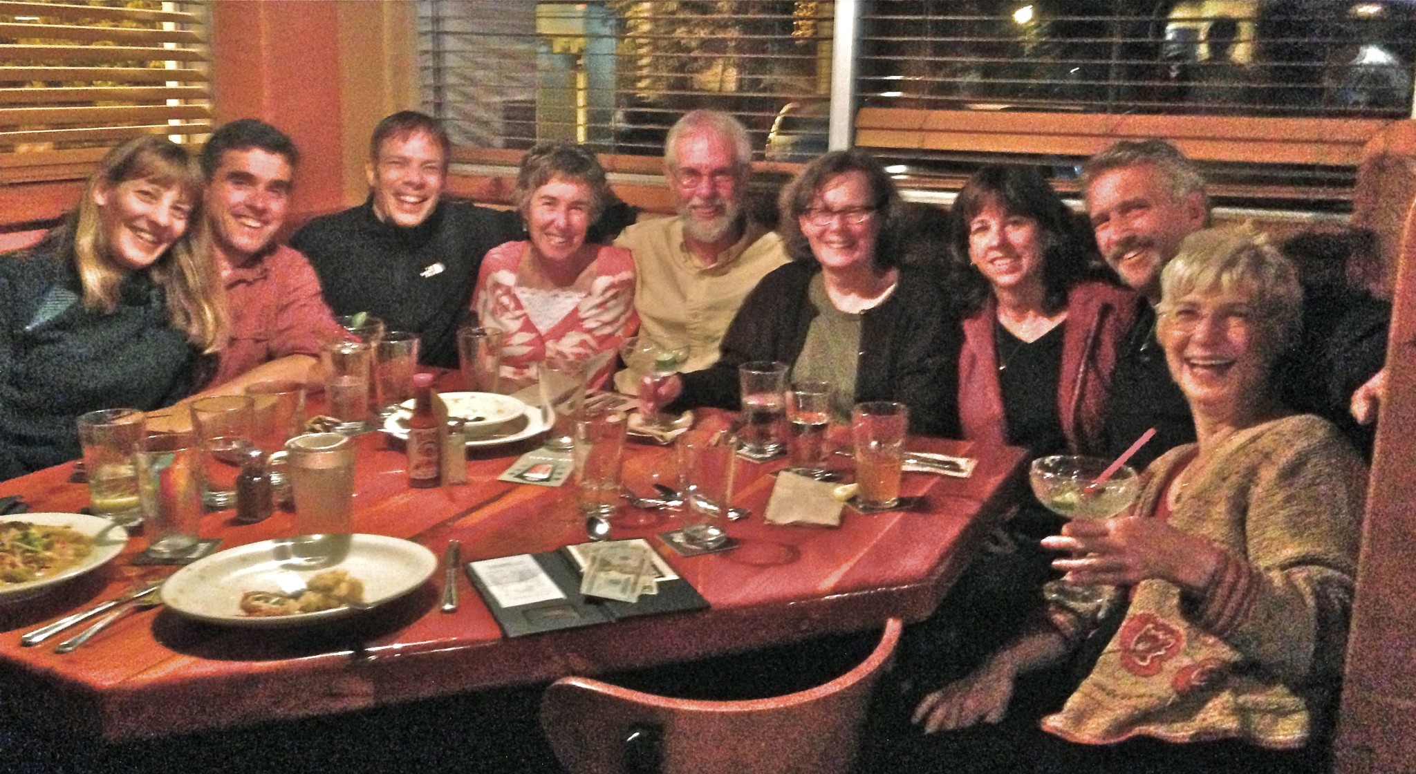 Group of people enjoying a meal together at Ravens' Roost Cohousing.