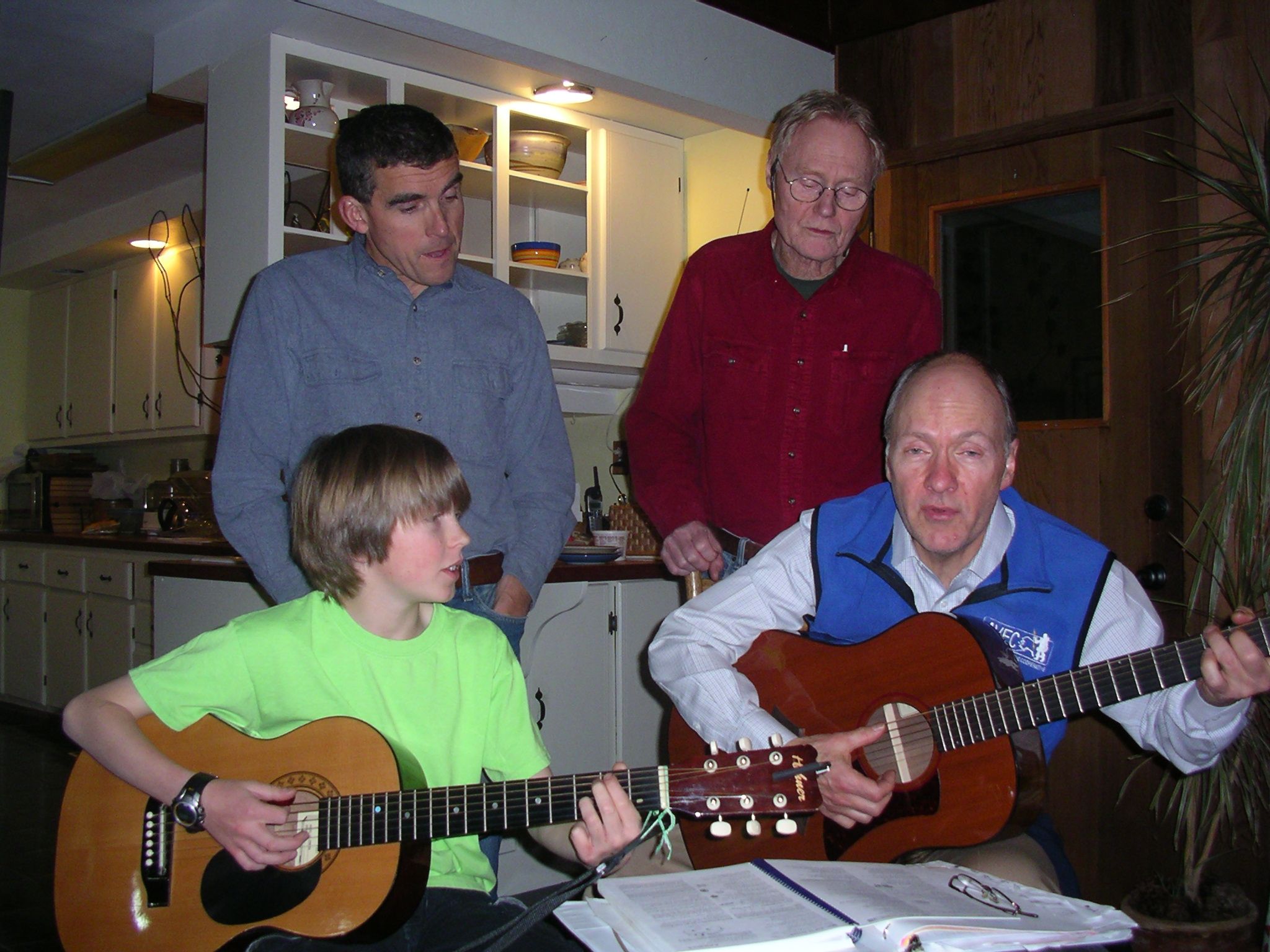 Group of people playing guitars and enjoying music at Ravens' Roost Cohousing.