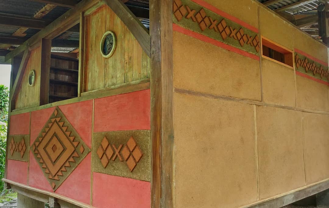 Traditional community building with colorful geometric patterns and wooden accents.
