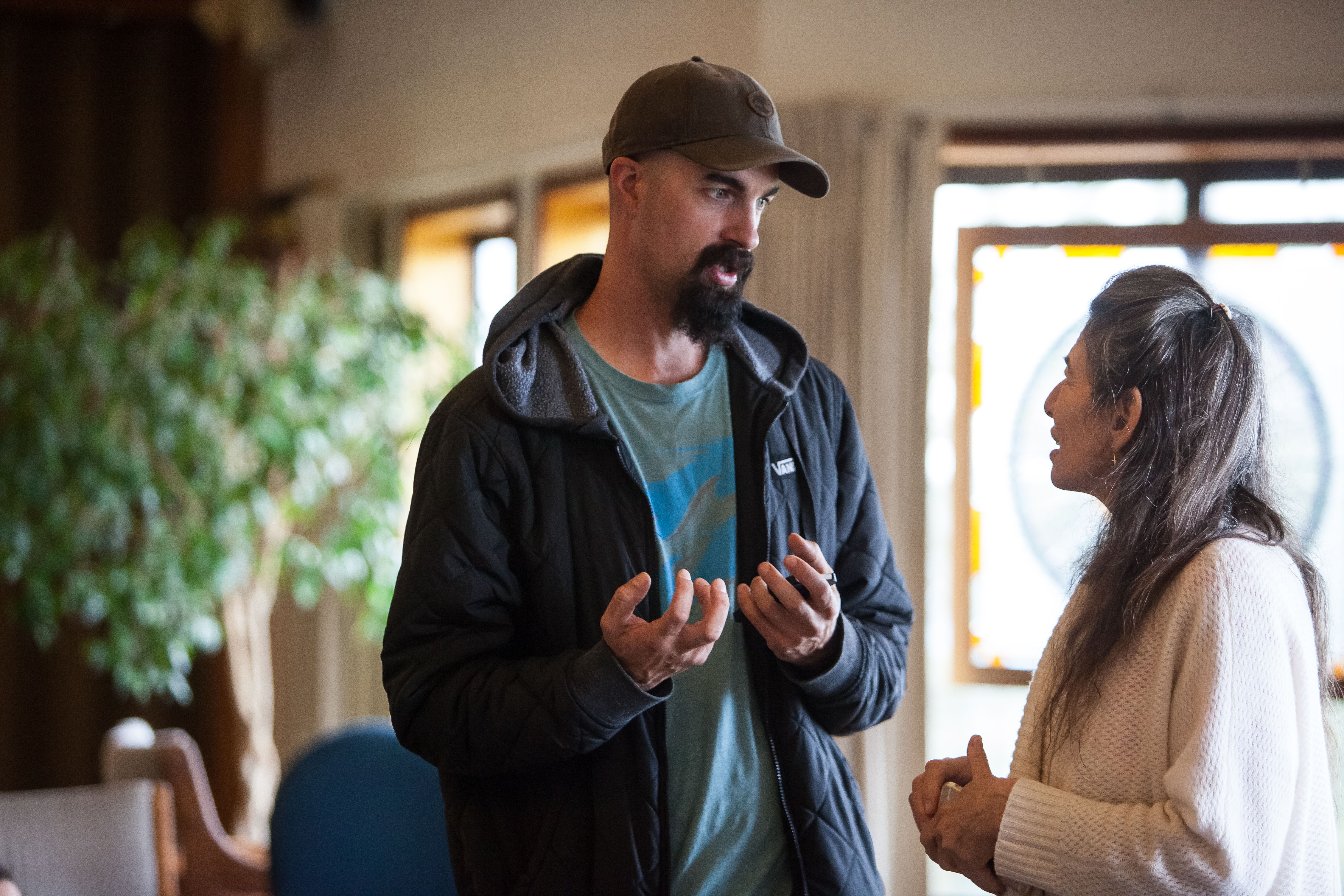 Man and woman having a meaningful discussion indoors at Mount Madonna Center.