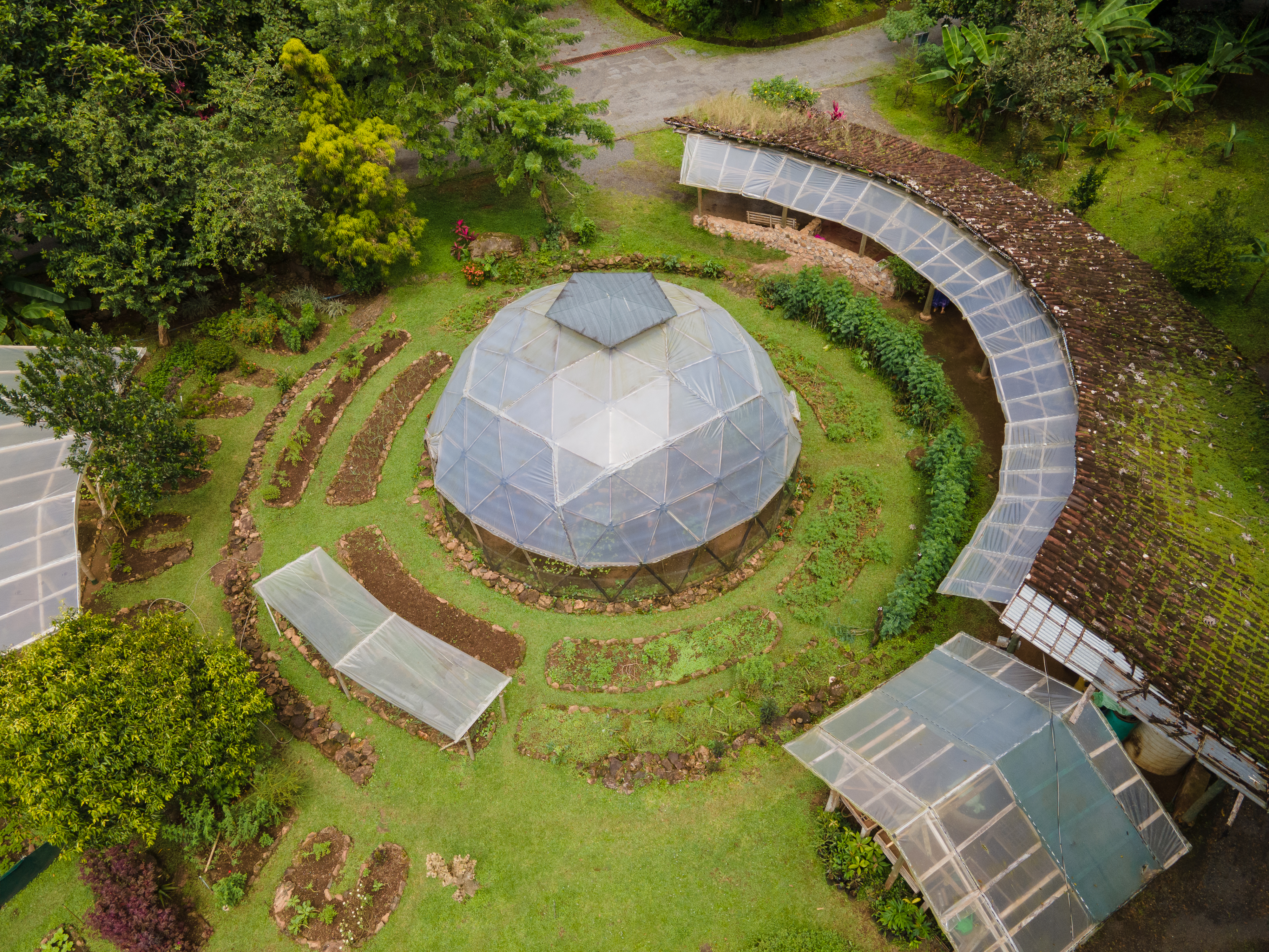 Eco-friendly geodesic dome with surrounding gardens in Costa Rica.