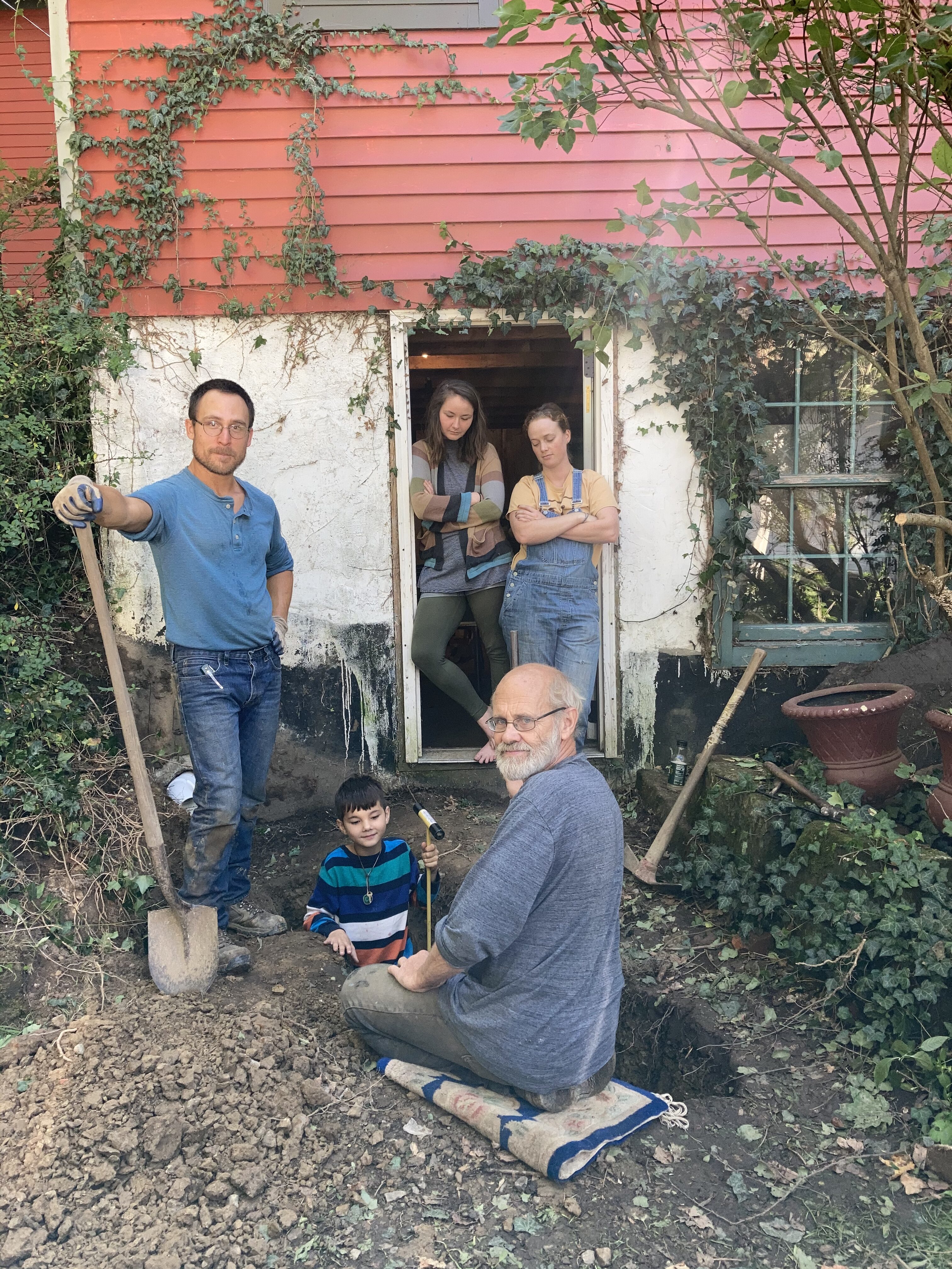 Group of people working together in a community garden at Stone Garden Farm.