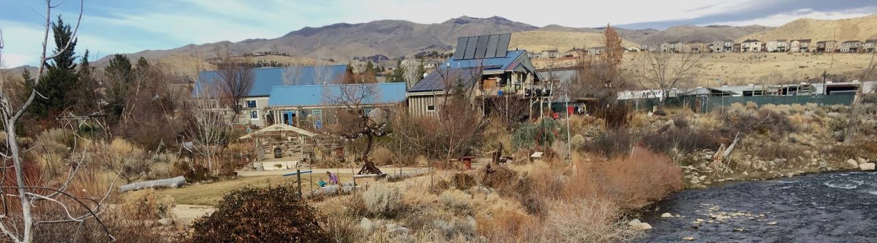 Scenic view of community buildings and natural landscape in a rural setting.