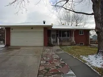 Single-story brick house with attached garage and front porch.