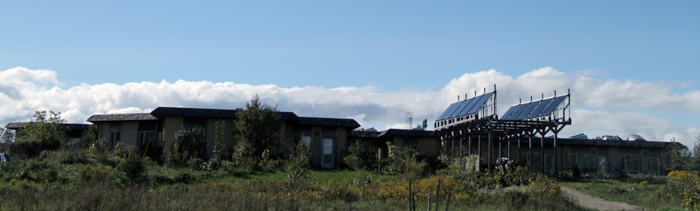 Eco-friendly homes with solar panels in an intentional community setting.