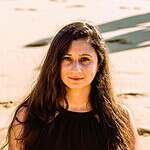 Portrait of a woman at the beach for community-focused SEO.