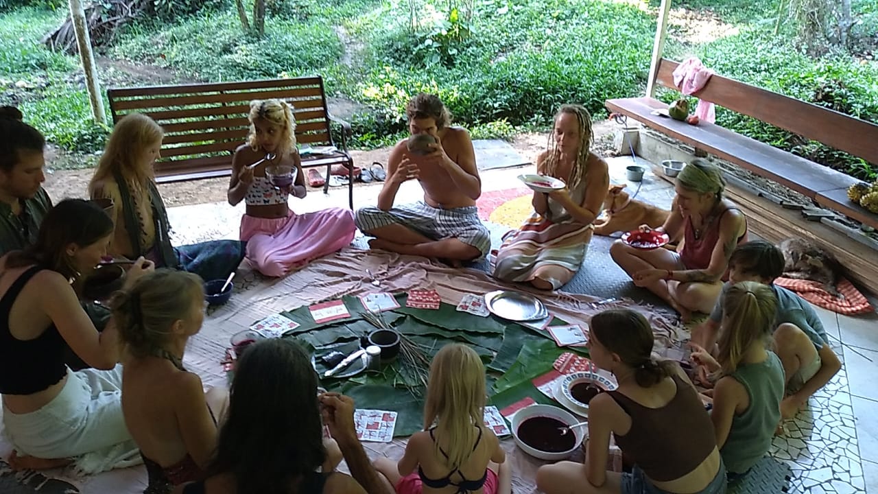 Group of people sitting in a circle during a community event at Valle Armonia.