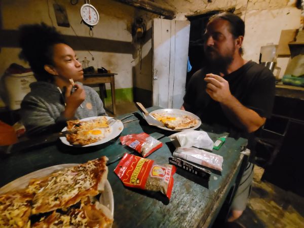 People enjoying a meal together in a cozy, rustic setting.