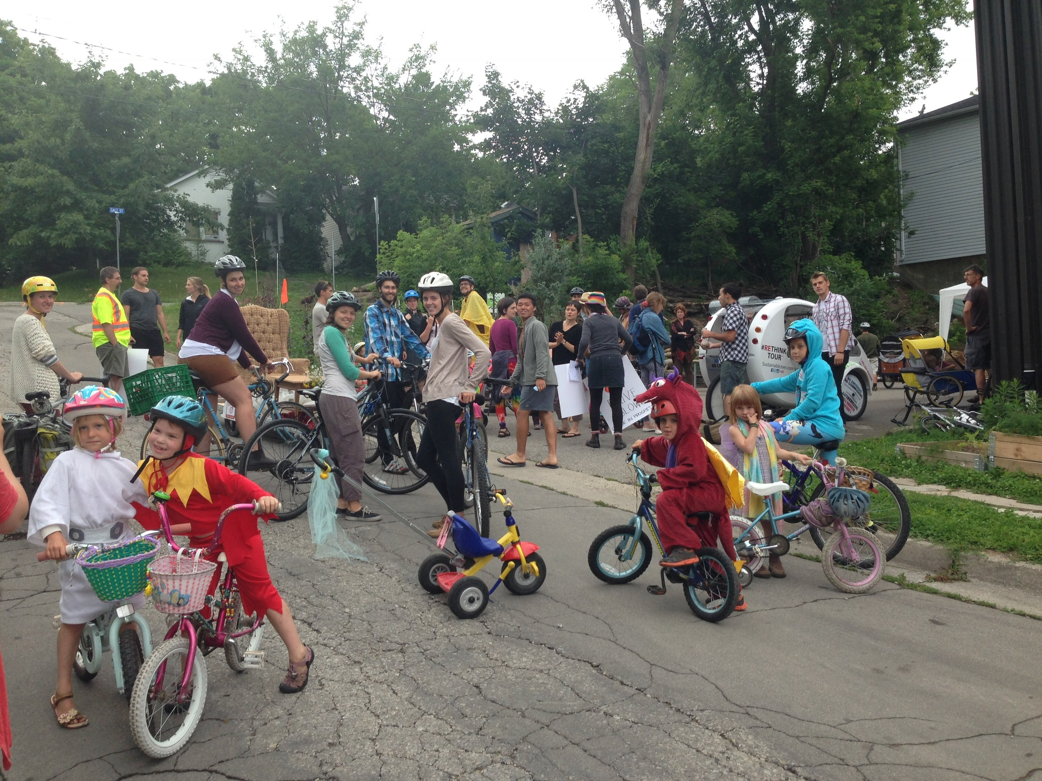 Children and adults enjoying a community event with bikes and outdoor activities.