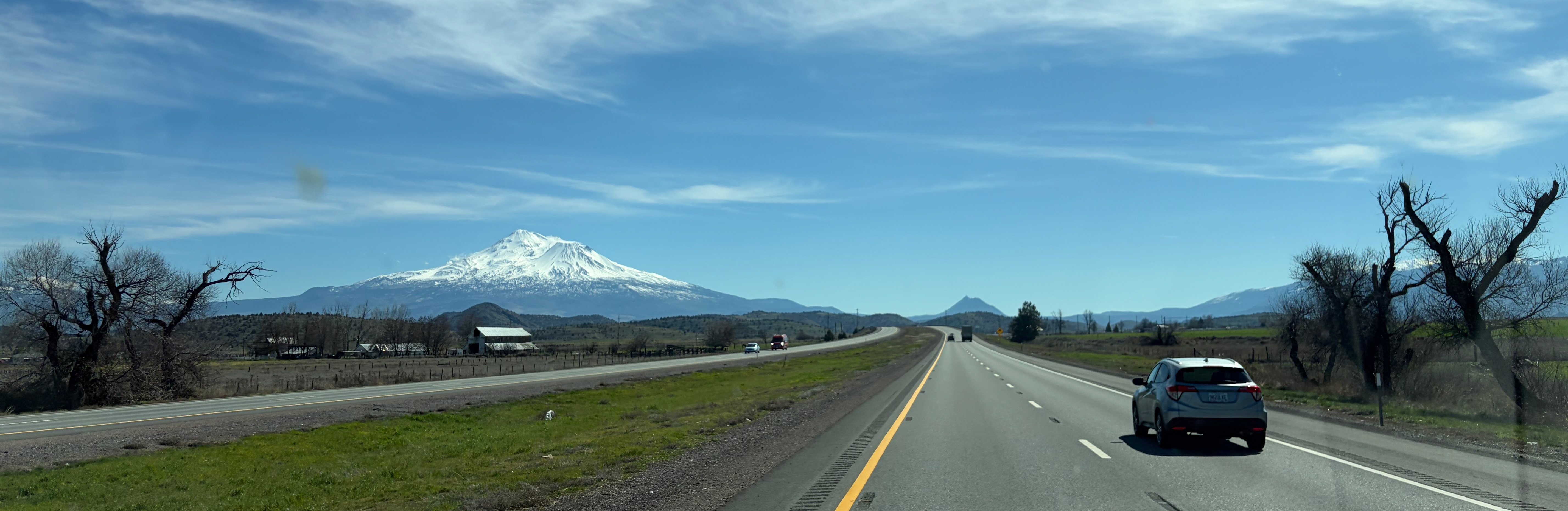 Open highway with Mount St. Helens in the background and clear blue sky.