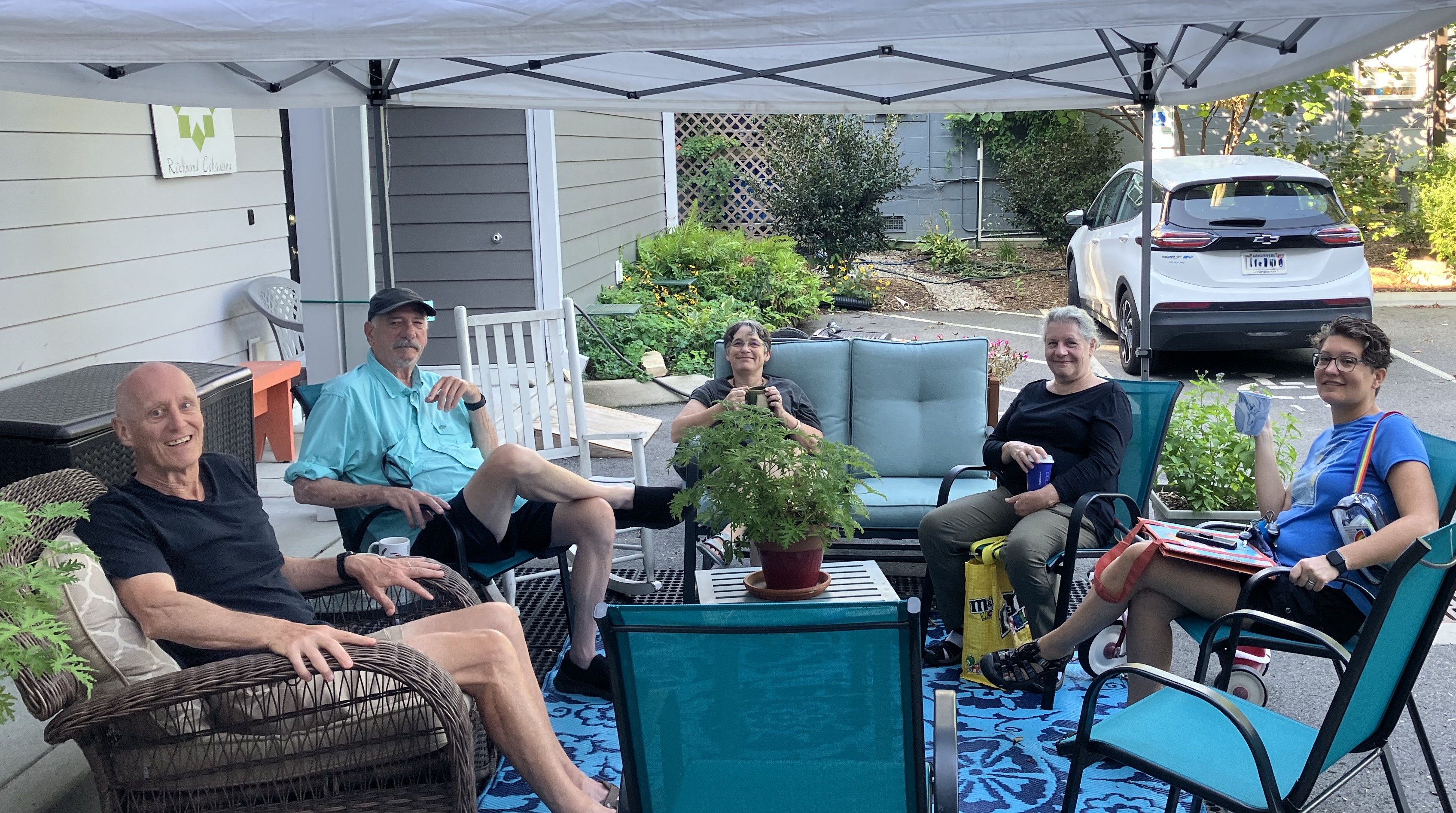 Group of people relaxing outdoors at Richmond Cohousing community gathering.