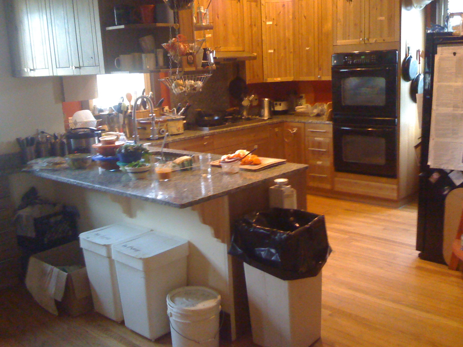 Warm kitchen with wooden cabinets and modern appliances in Maitri House.