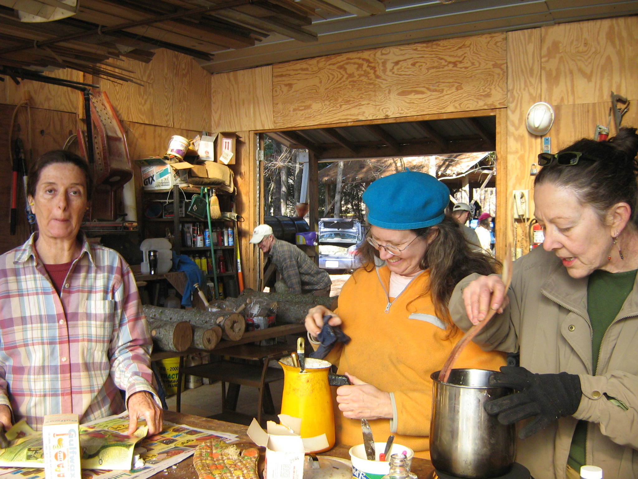 People preparing food together in a communal workshop setting.