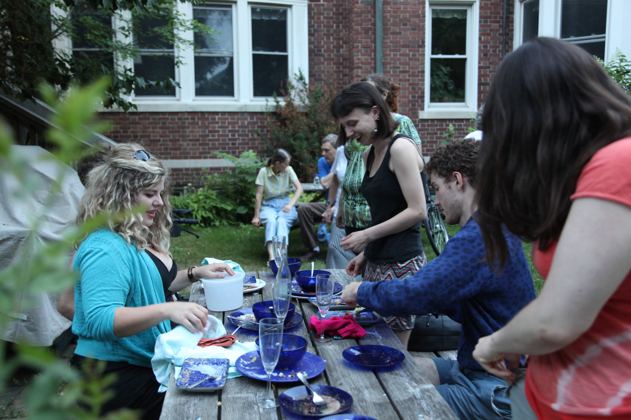 People enjoying outdoor meal at Monterey Cohousing community event.