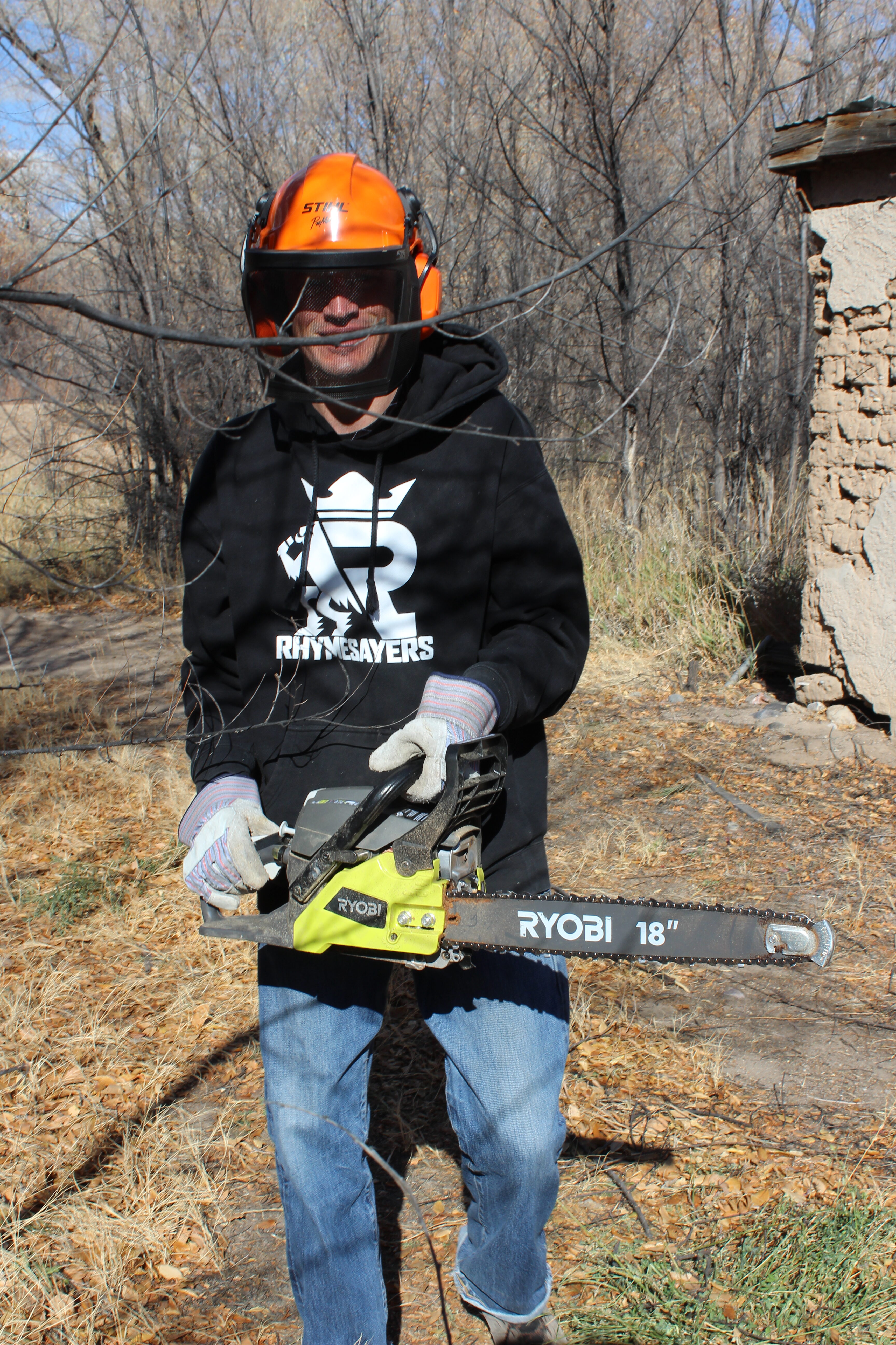 Volunteer with safety gear using a chainsaw at Rio Grande Refuge.