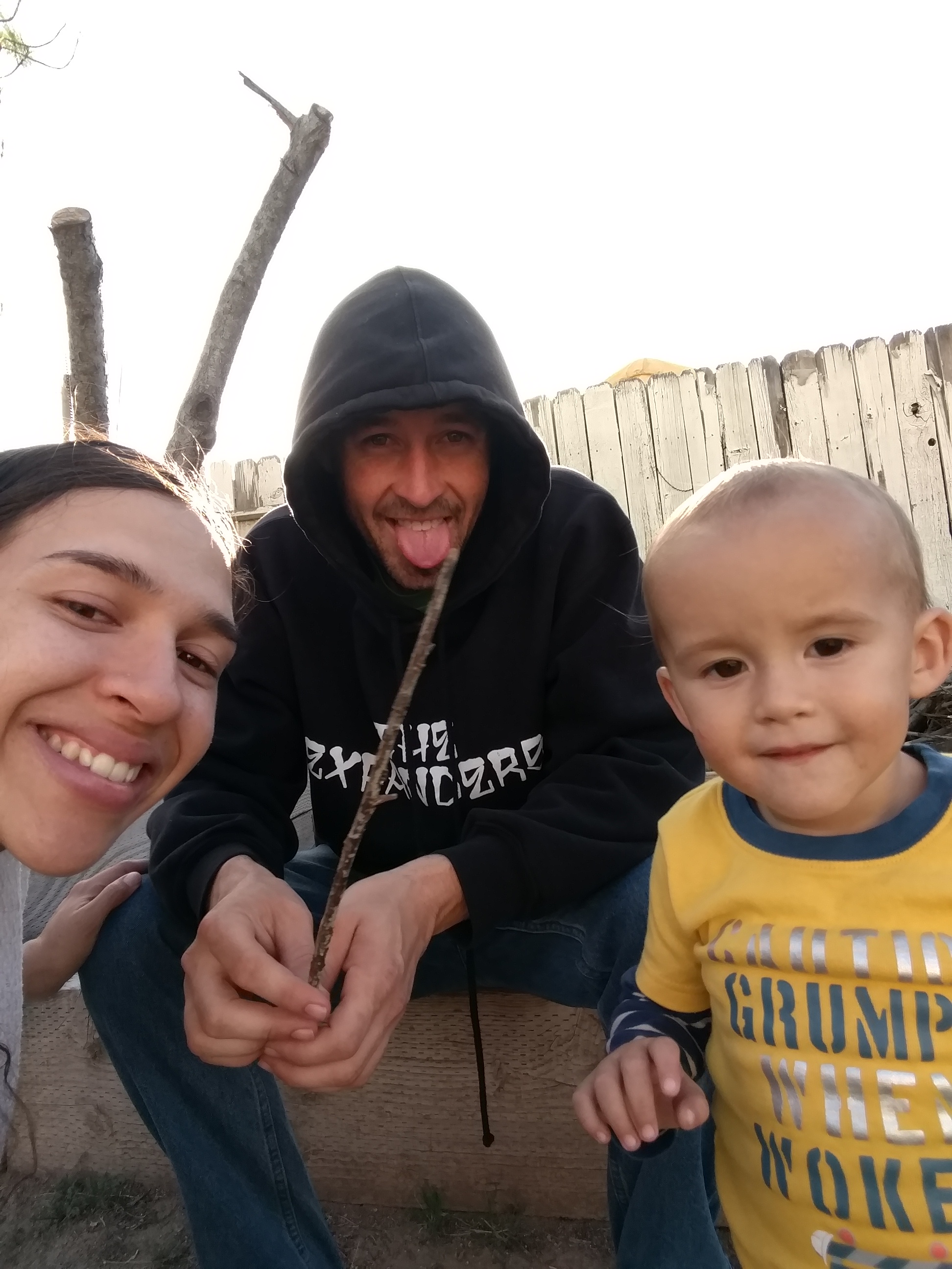 People smiling outdoors at Roots to Heal Farmacy community event.