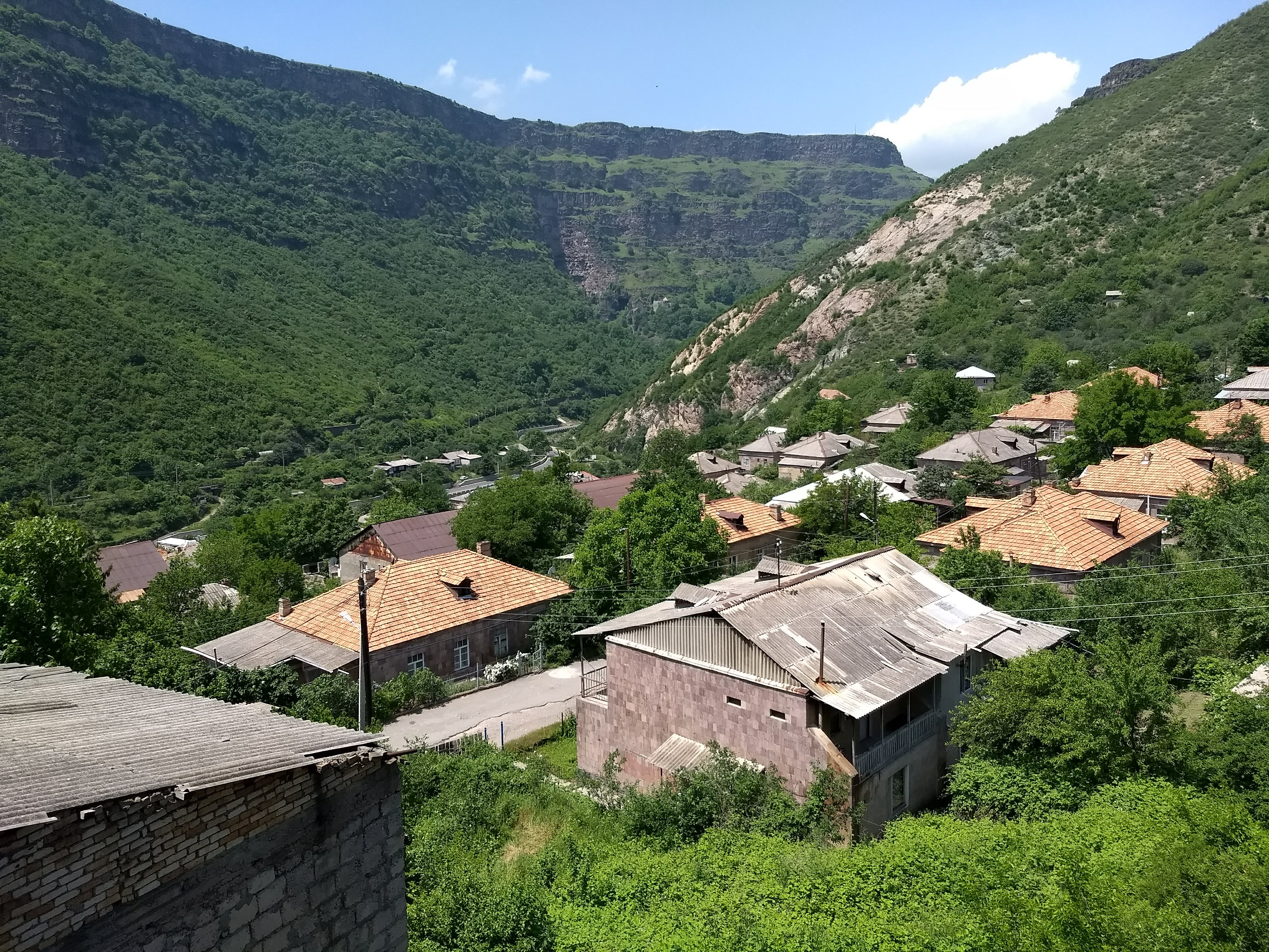 Scenic view of a community village in a lush green valley.