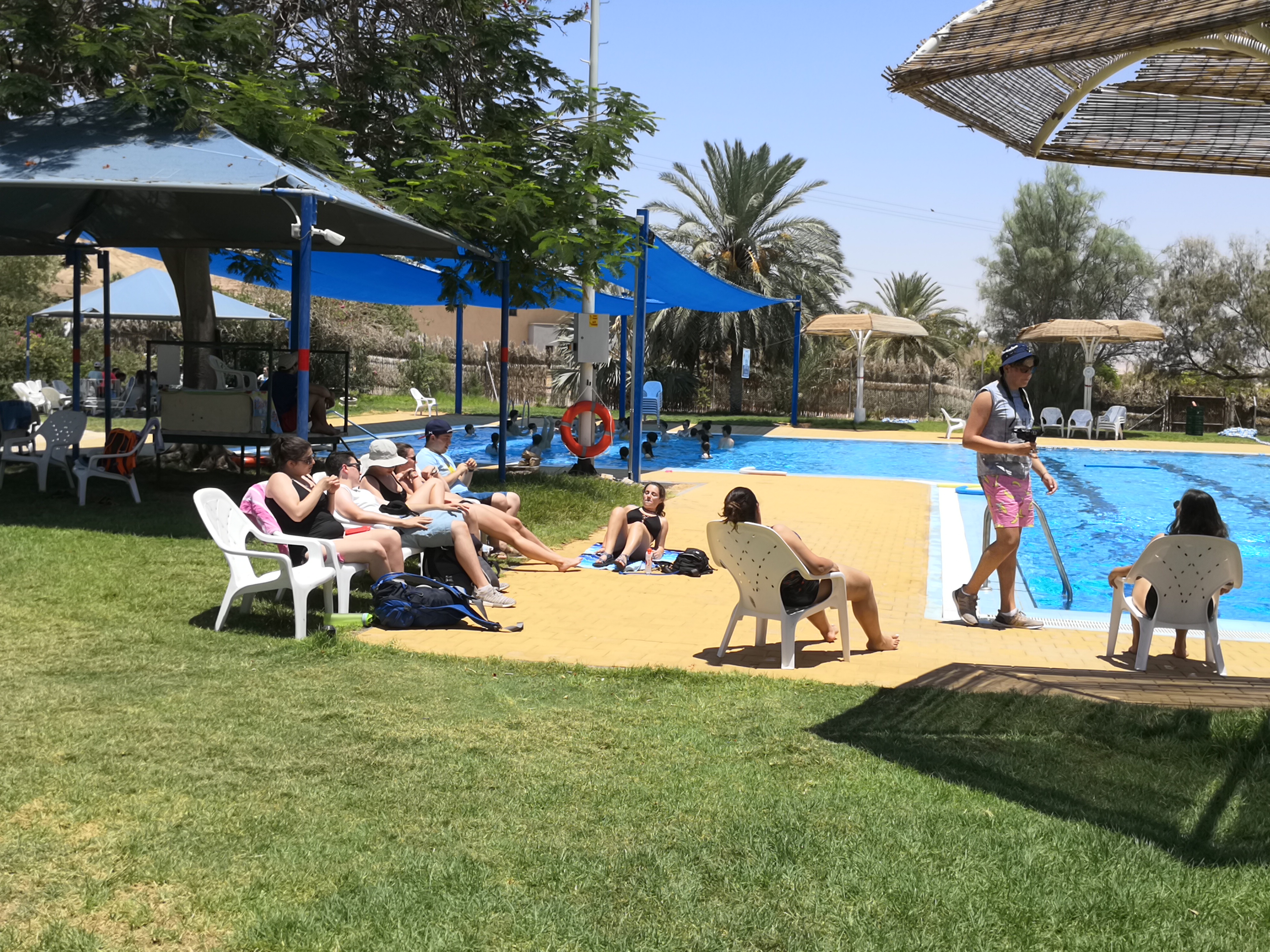 People relaxing by the pool at Kibbutz Ketura in Israel.