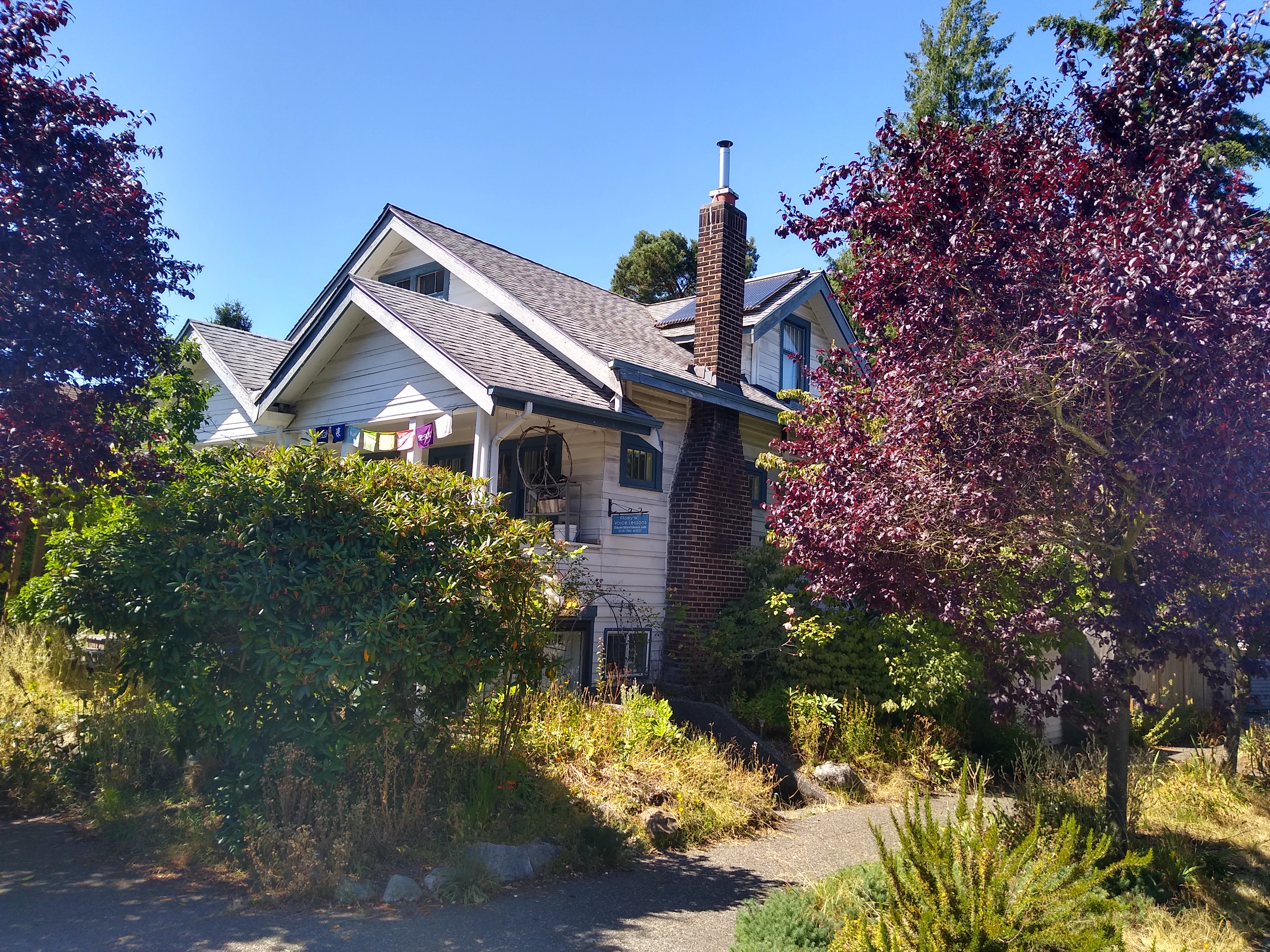 Beautiful house surrounded by colorful trees and lush greenery.