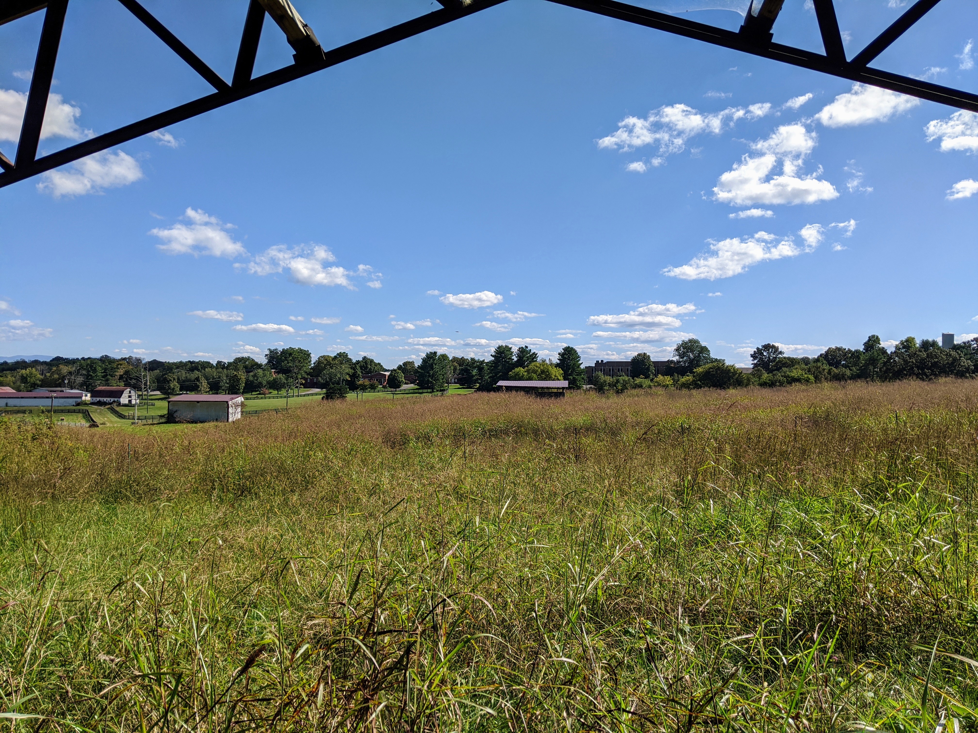 Scenic open field view at Hiwassee Bruderhof Community under blue sky.