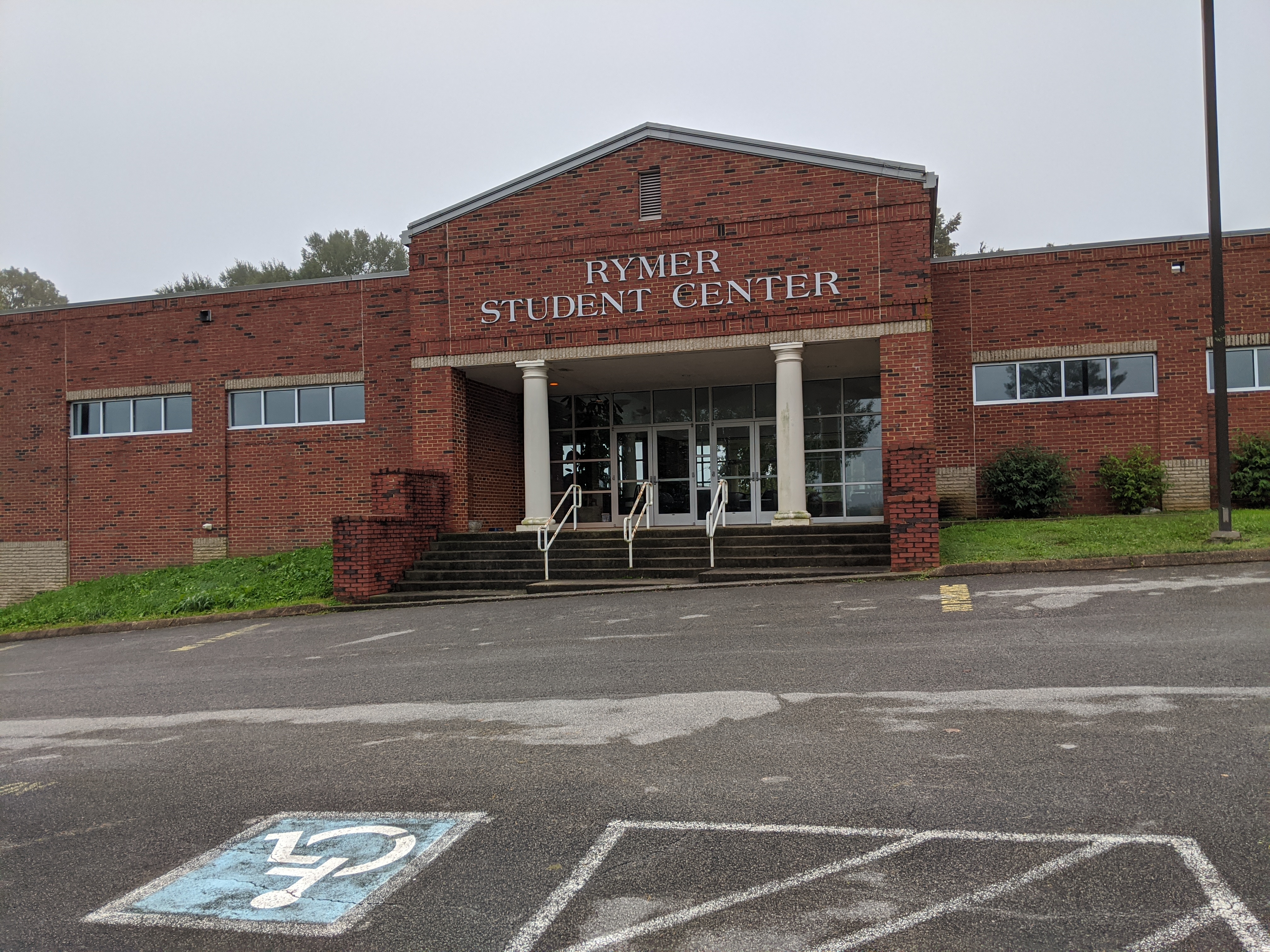 Rymer Student Center building with accessible parking space in front.