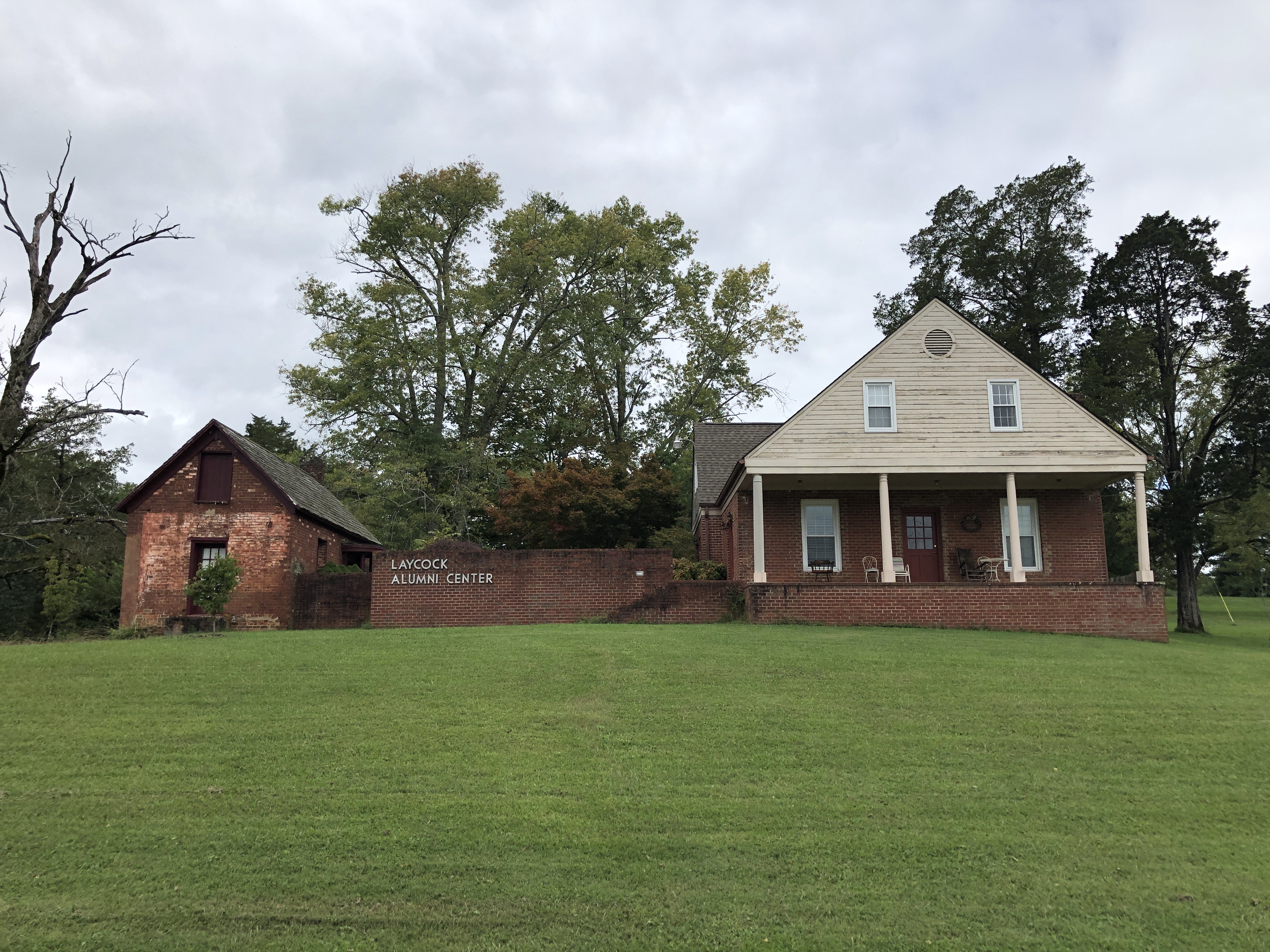 Community building at Hiwassee Bruderhof in a lush green setting.