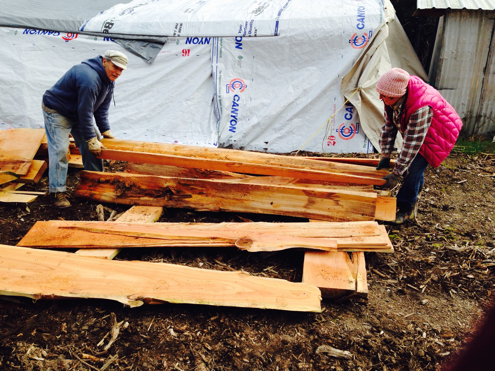 People working on wooden construction at Upper Langley community site.
