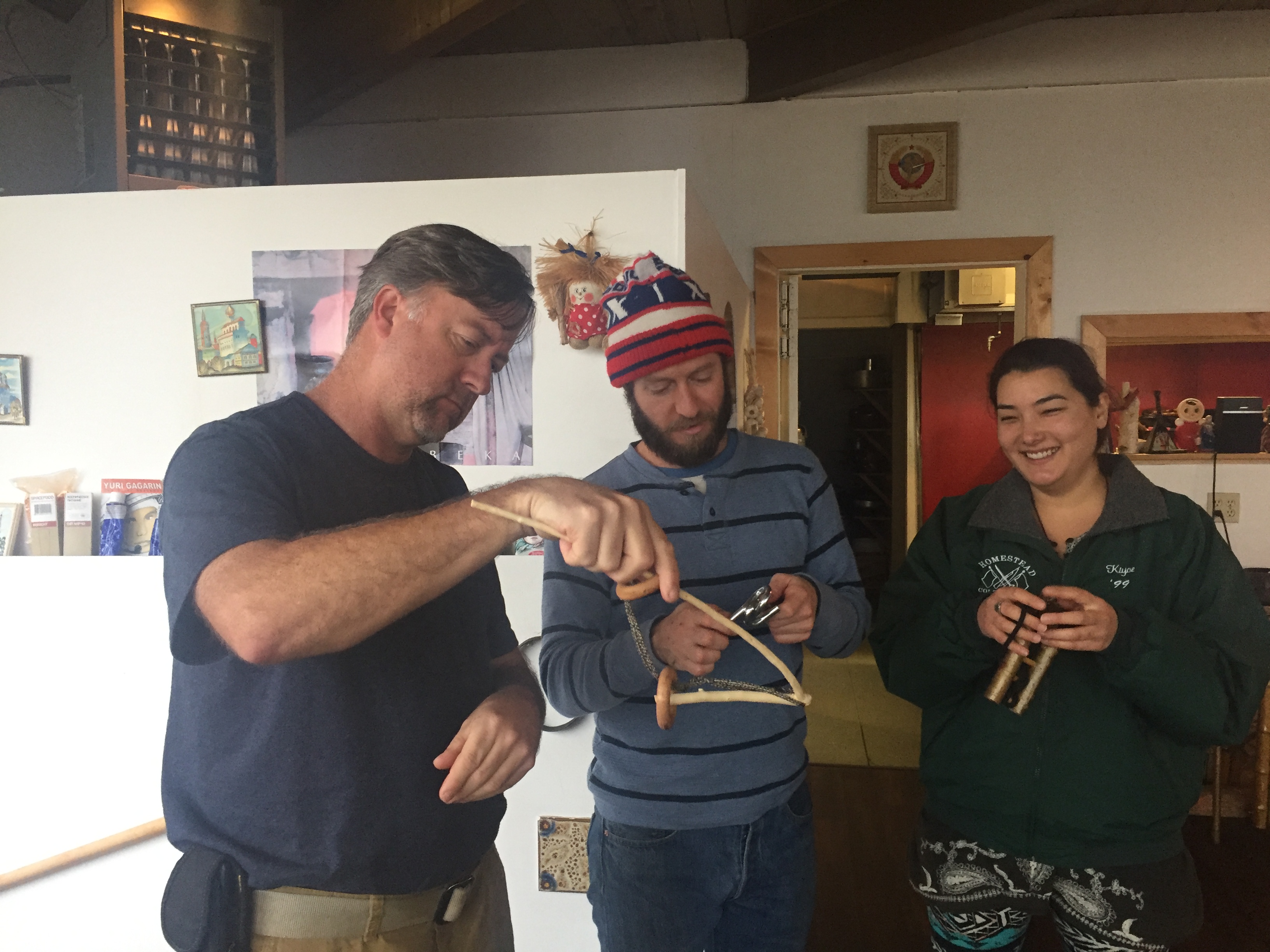 People enjoying a community event at Russian House with traditional crafts.