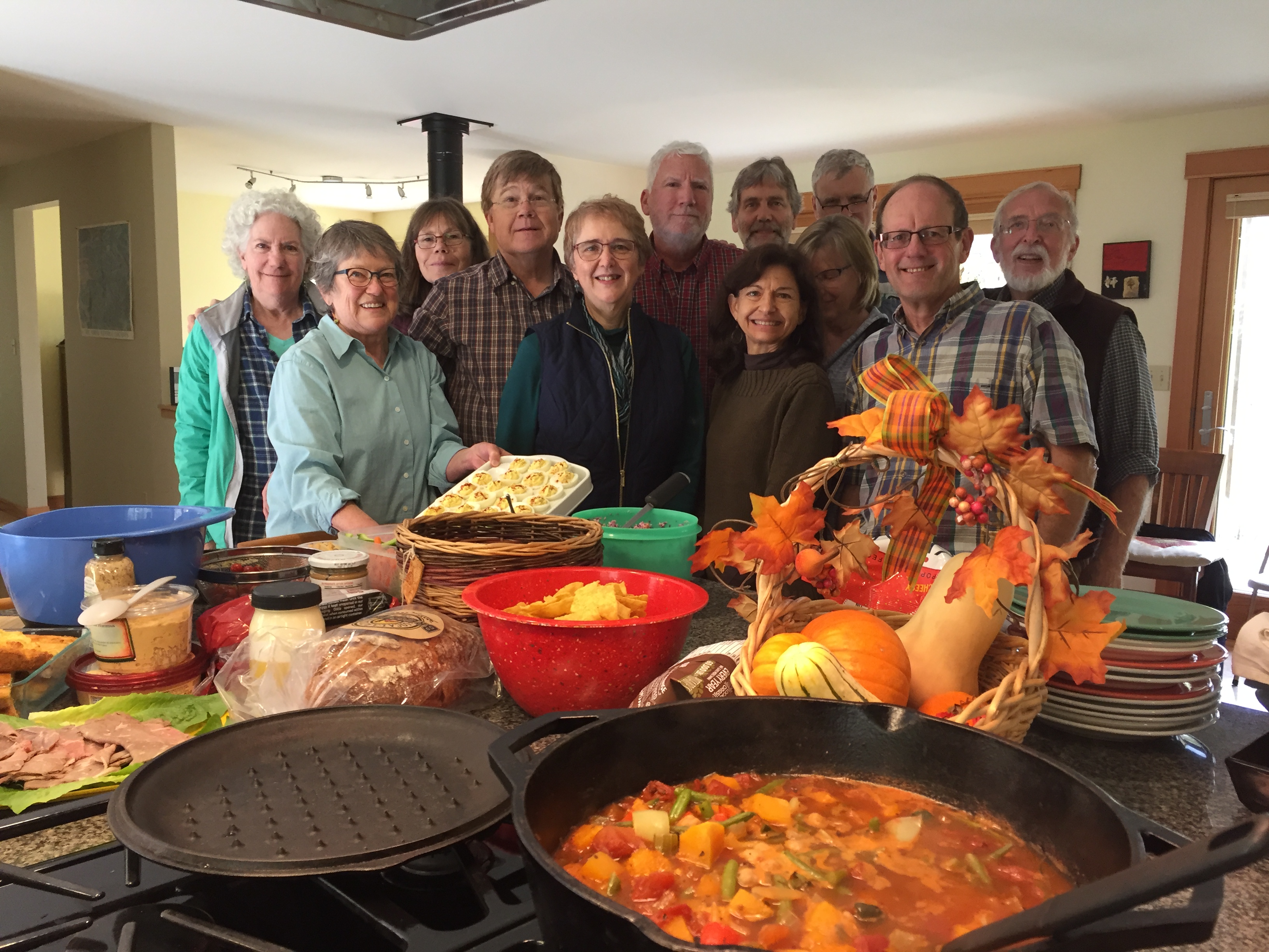 Group of diverse people smiling at a community event in Skagit Commons.