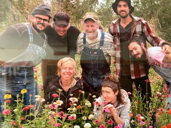 Group of diverse people smiling in a garden at Sandhill Farm.