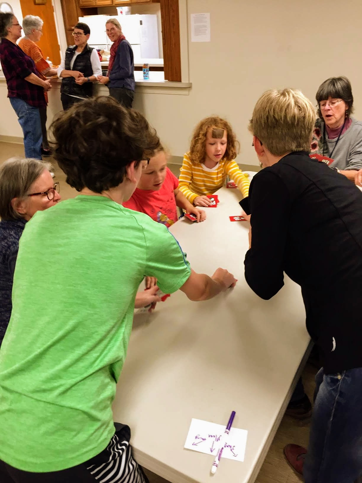 People playing card game at community event in Harrisonburg.