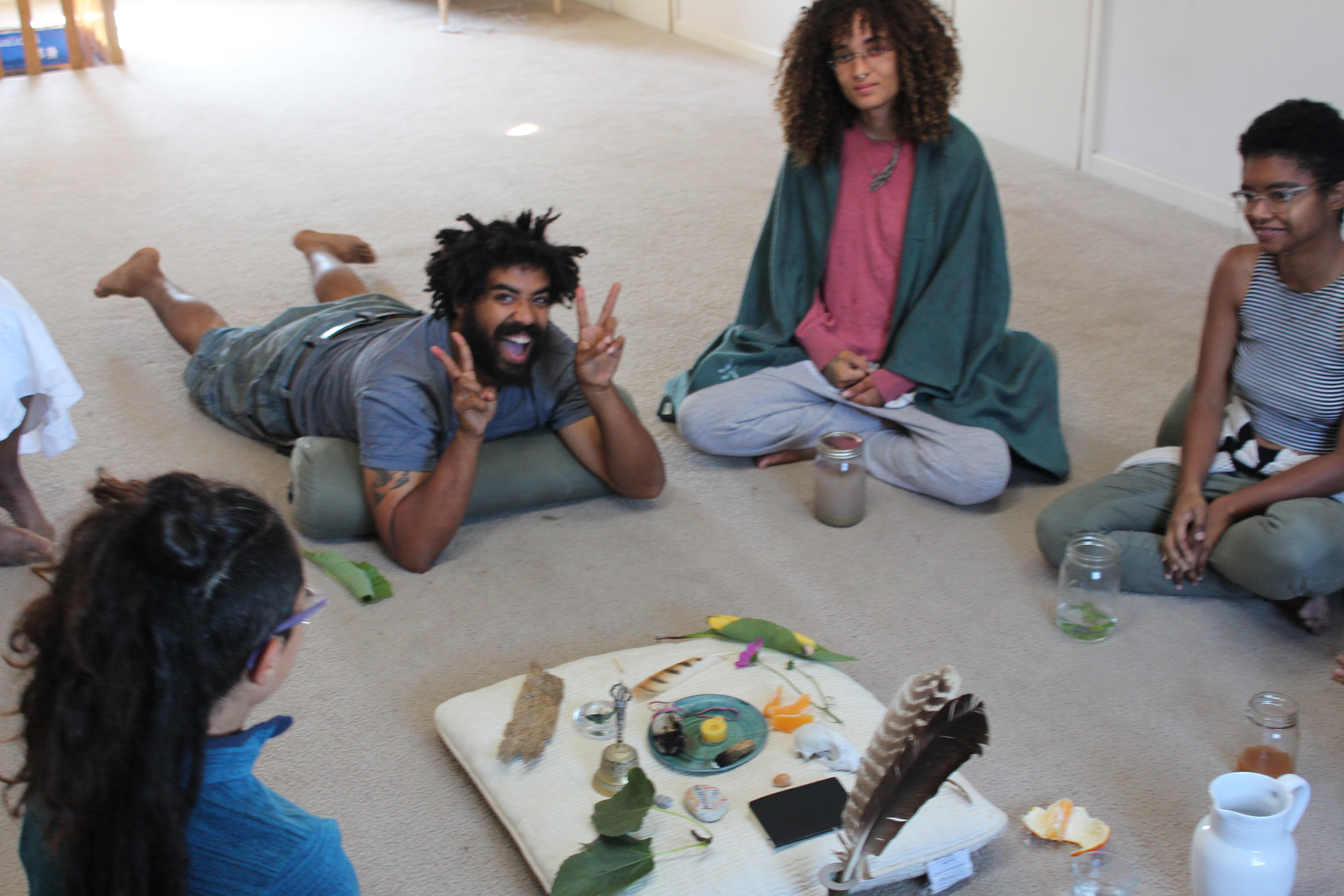 People sitting in a circle during a community event at Canticle Farm.