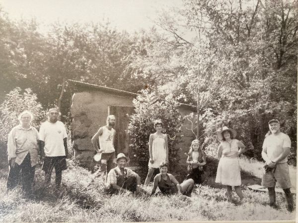 Black and white photo of people gathered outdoors at Sandhill Farm.