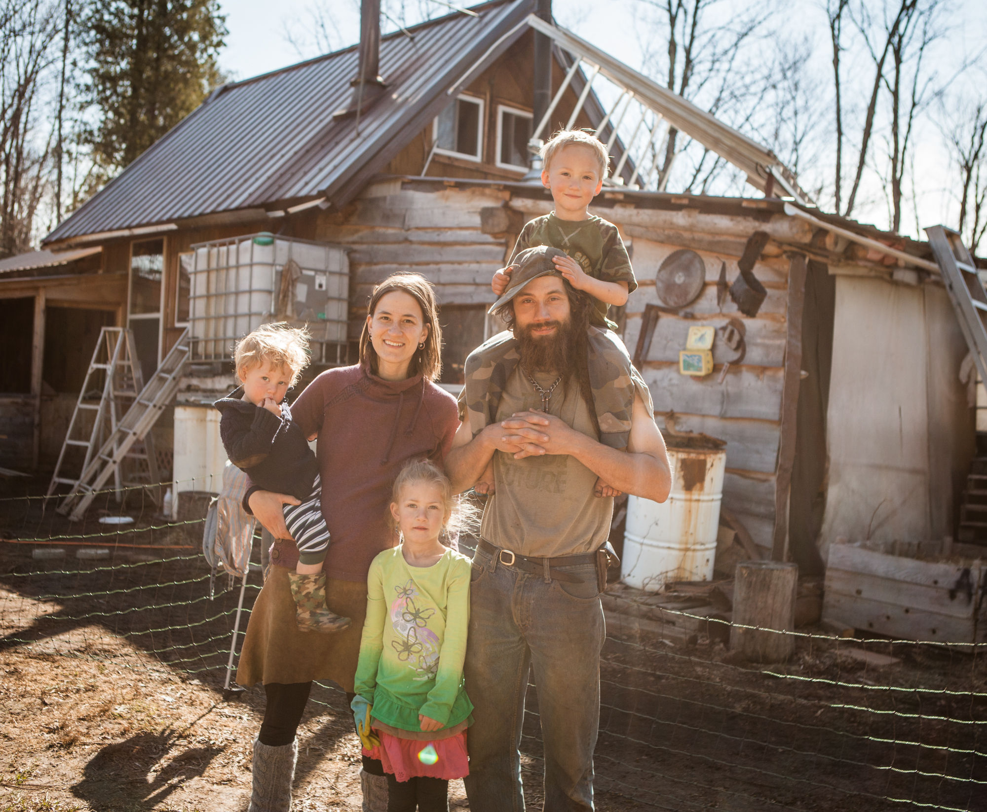 Family with children at sustainable intentional community homestead.