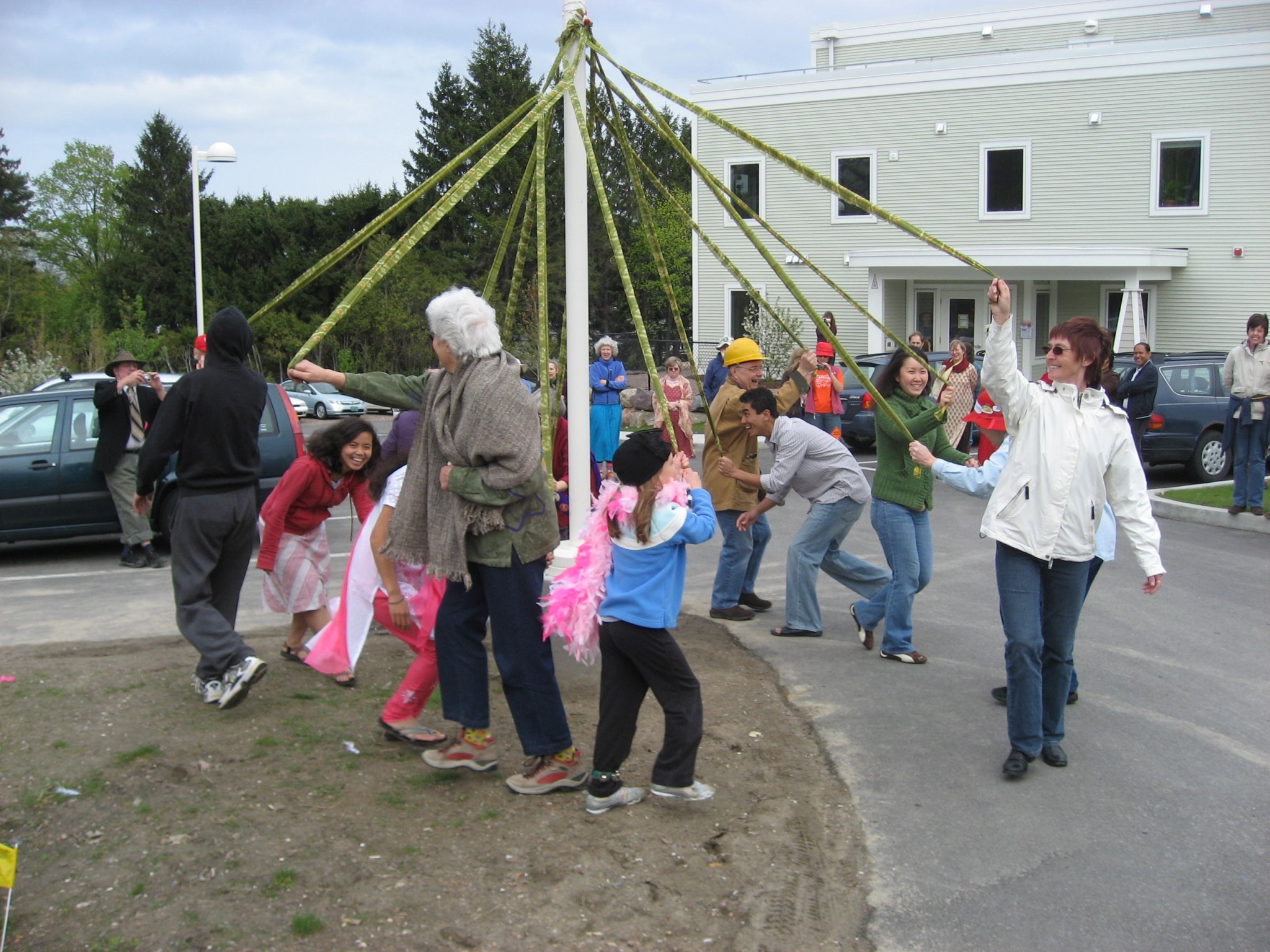 People enjoying a traditional maypole dance at Burlington Cohousing East Village.