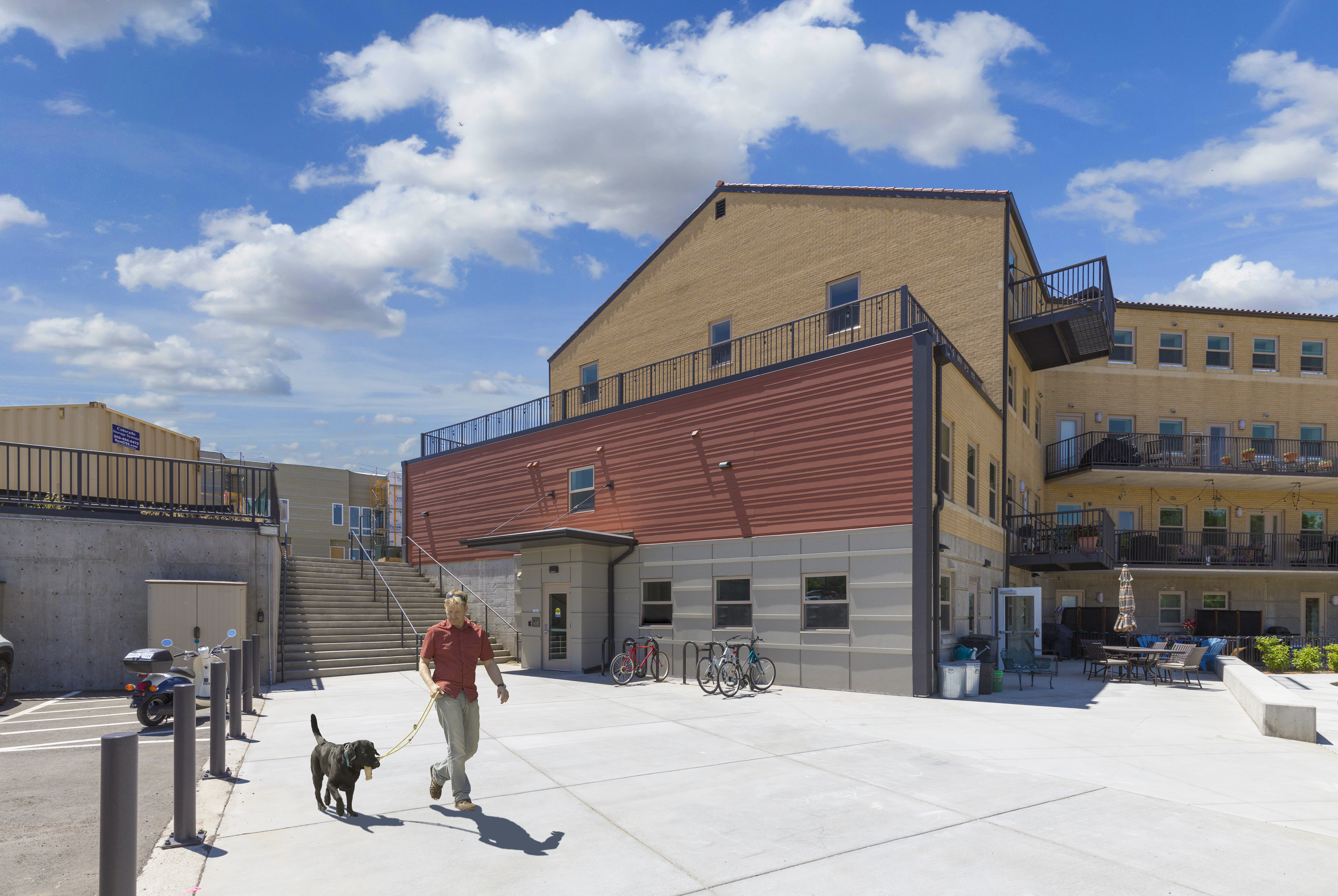 Modern cohousing community building with outdoor space and bicycles.