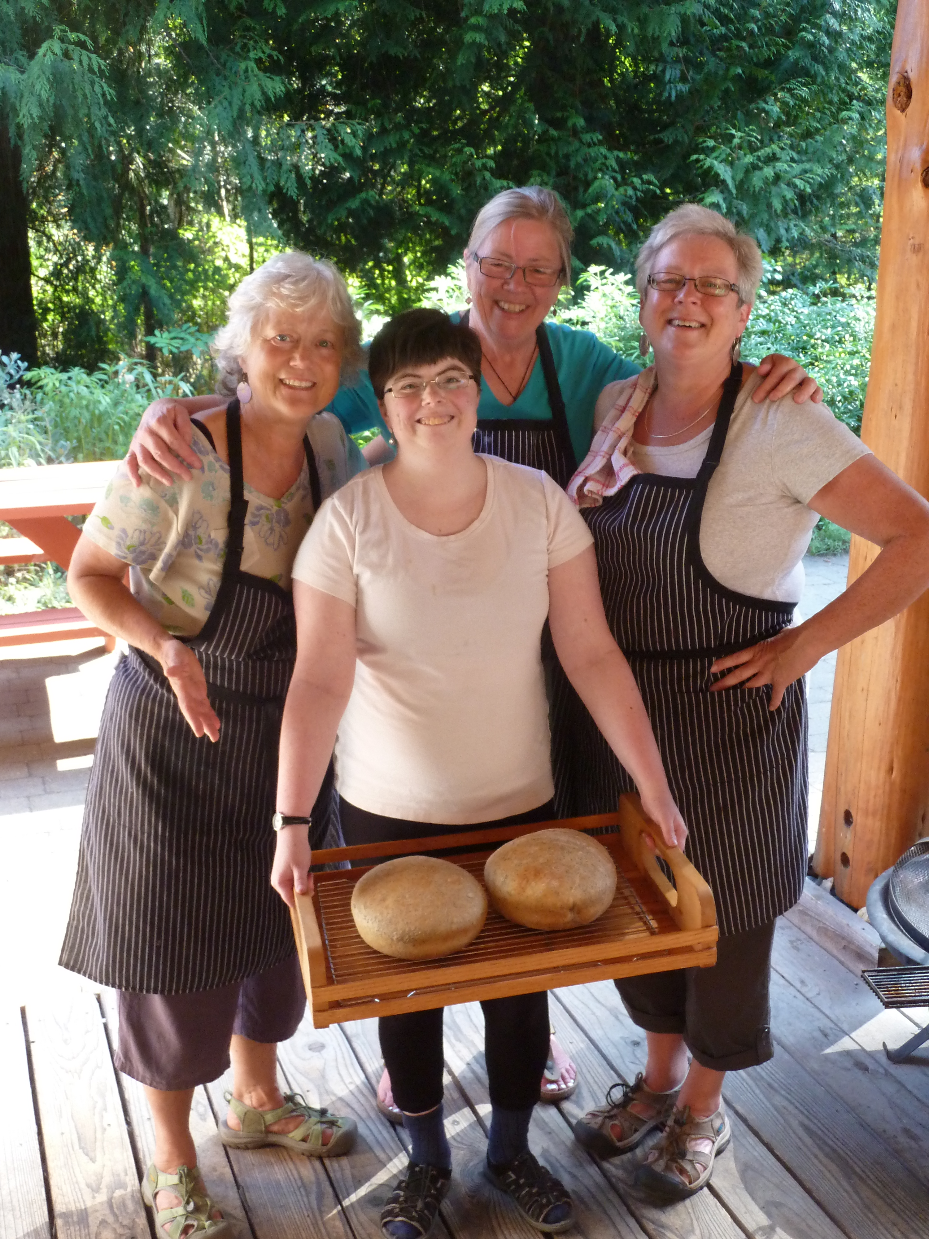 Group of women with bread loaves at Roberts Creek Cohousing.