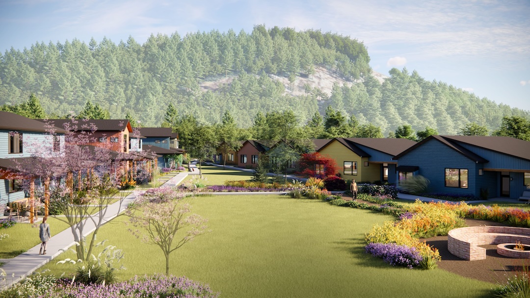 Community neighborhood with colorful houses and lush greenery in a scenic setting.