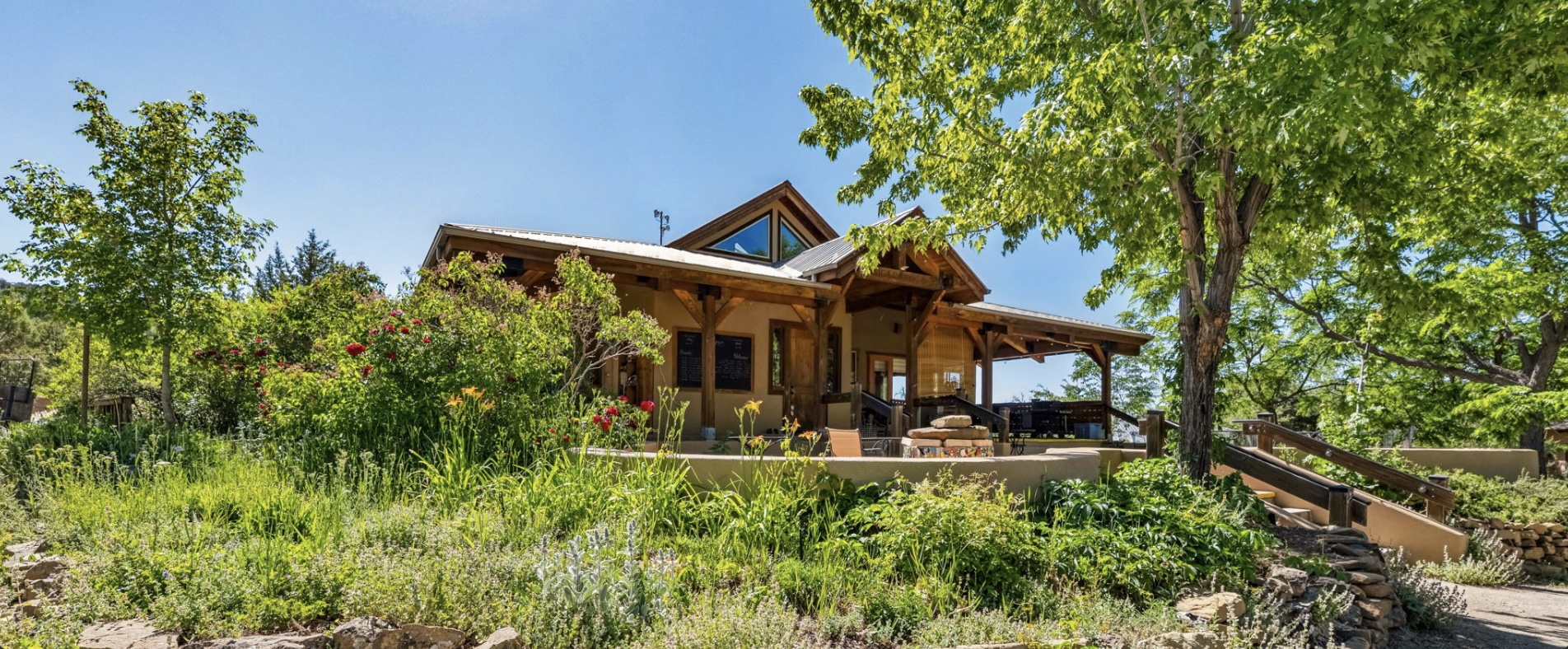 Cozy house surrounded by lush greenery and trees in an intentional community setting.