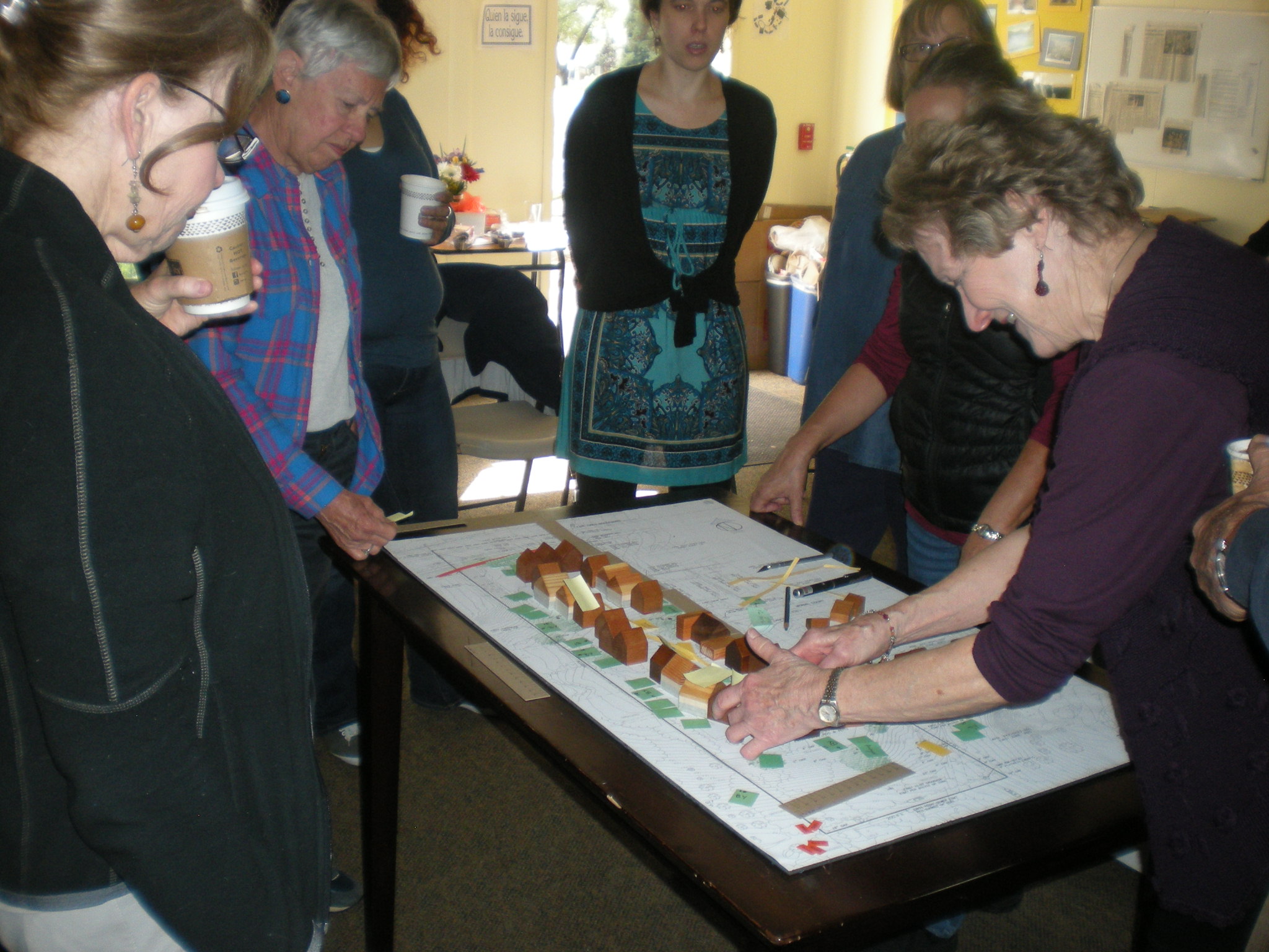 Group of people engaged in community planning at Fair Oaks EcoHousing.