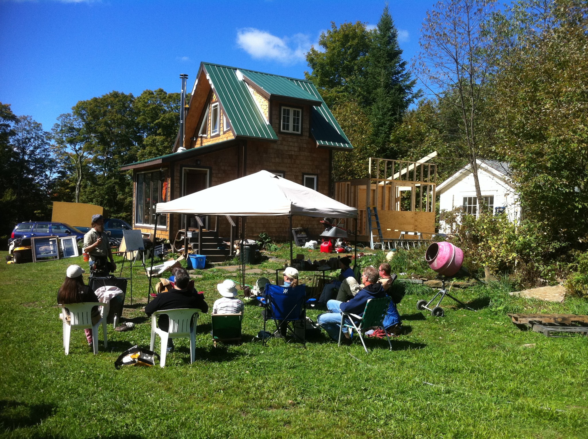 People gathered outdoors at Headwaters Community for a social event.